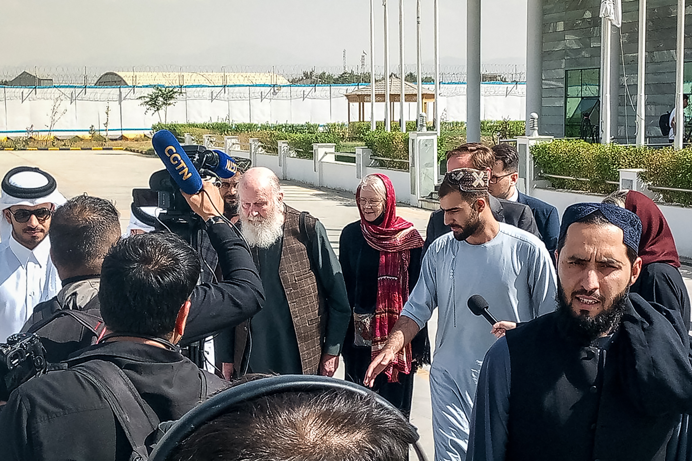 British nationals Peter Reynolds (centre L) and his wife Barbara (centre R) speak with journalists at Kabul airport, Afghanistan.