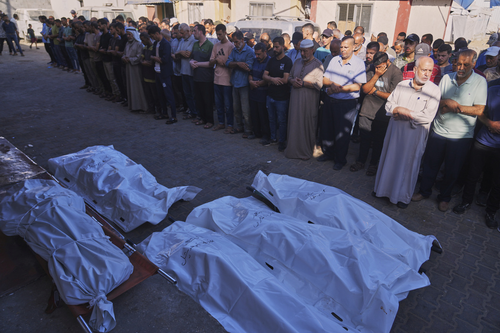 Palestinians gather around the dead outside Al-Aqsa Hospital in Deir al-Balah