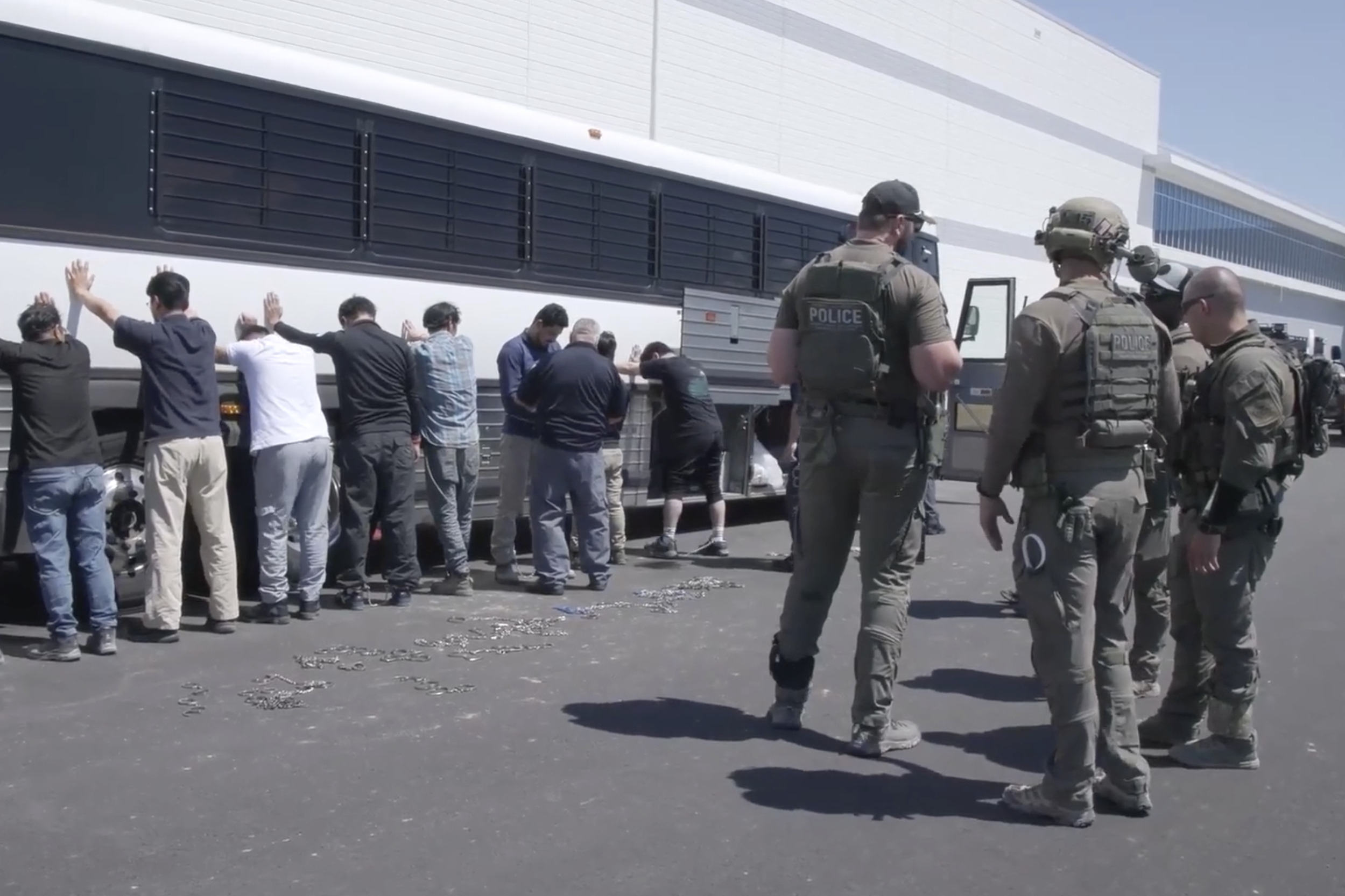 Manufacturing plant employees waiting to have their legs shackled at the Hyundai Motor Group’s electric vehicle plant, 