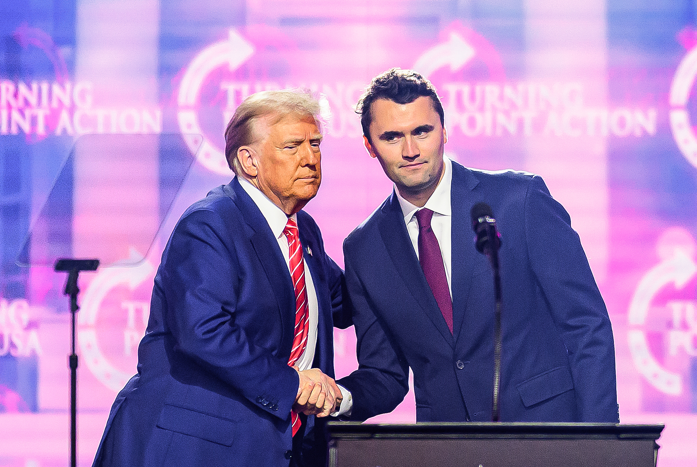 US right-wing activist Charlie Kirk (R) speaks on stage with President Donald Trump at America Fest 2024 in Phoenix, Arizona, on December 22, 2024.