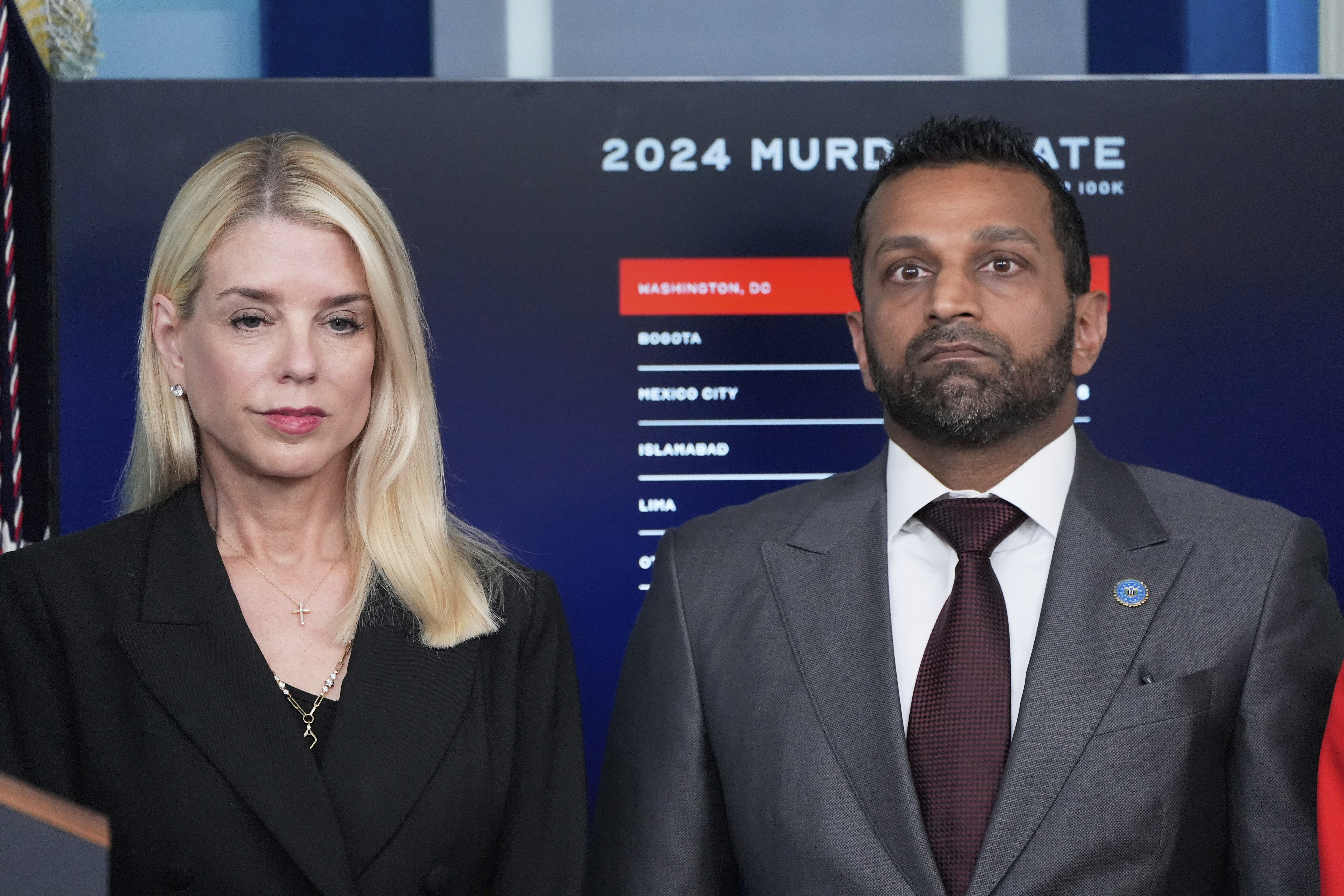 Attorney General Pam Bondi and FBI Director Kash Patel look on as President Donald Trump speaks with reporters in the James Brady Press Briefing Room at the White House, Monday, Aug. 11, 2025, in Washington. (AP Photo/Alex Brandon)