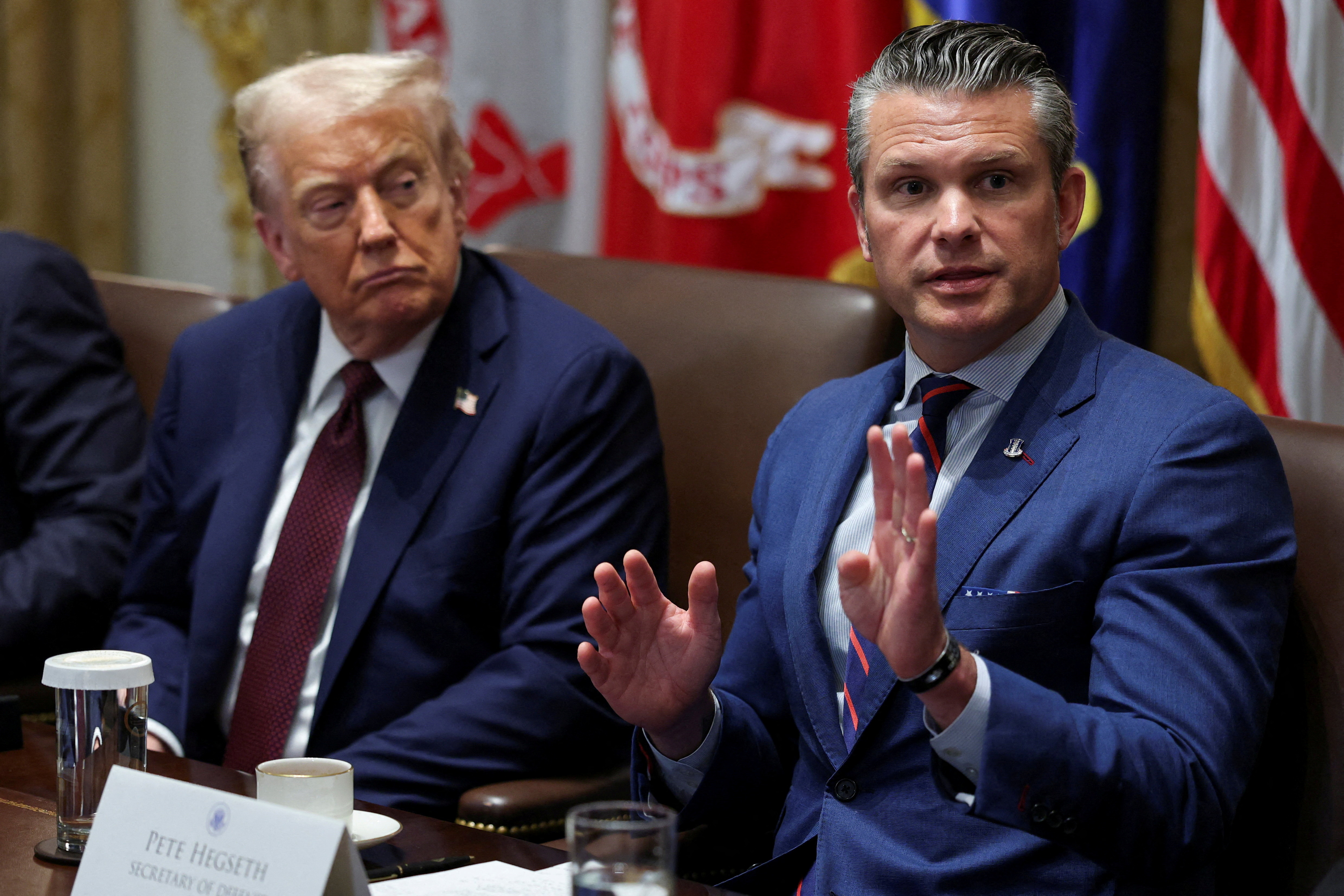 FILE PHOTO: U.S. President Donald Trump and Defense Secretary Pete Hegseth attend a cabinet meeting at the White House in Washington, D.C., U.S., August 26, 2025. REUTERS/Jonathan Ernst/File Photo