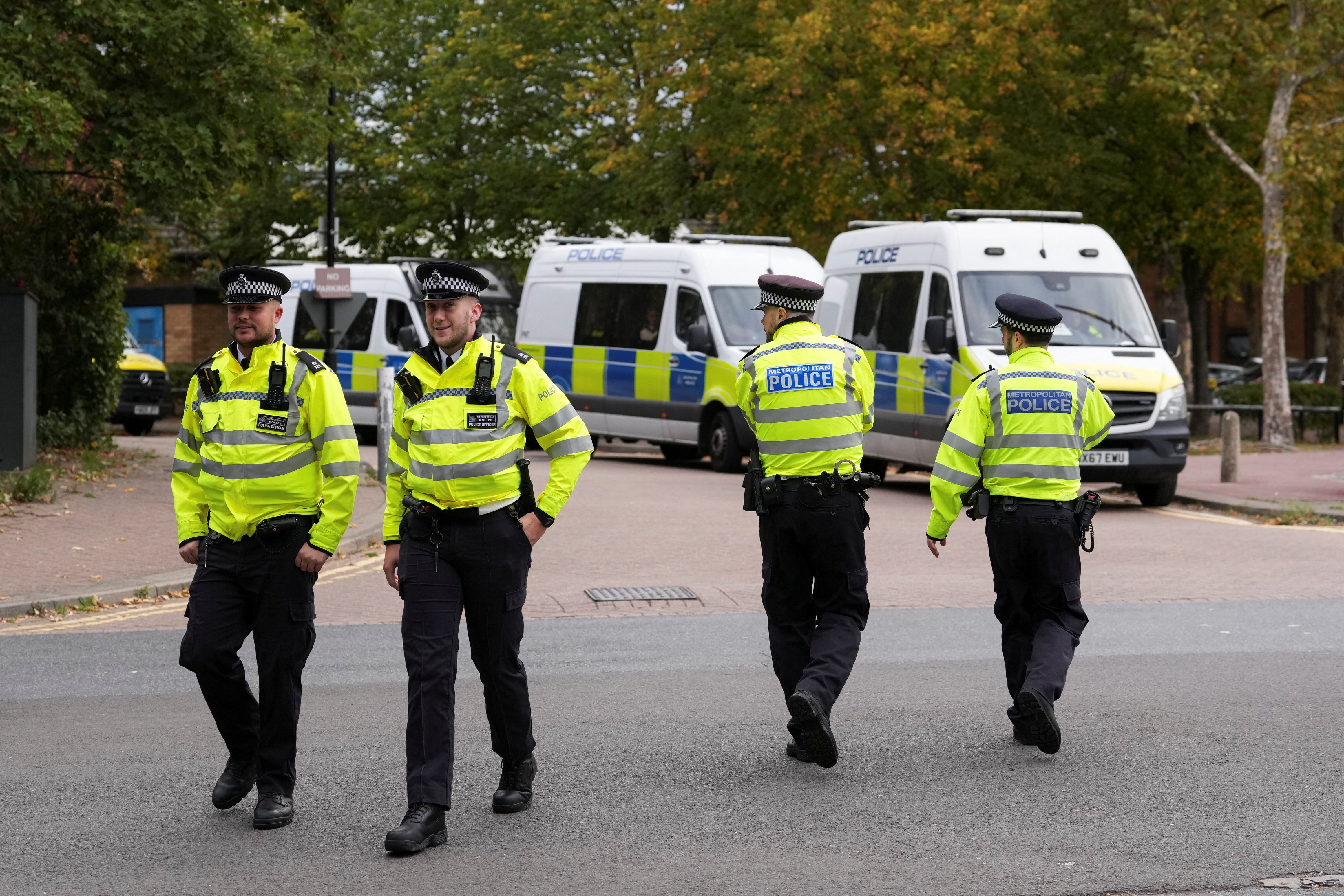 Police officers walk outside the Woolwich Crown Court ahead of the hearing of Kneecap member Liam O'Hanna