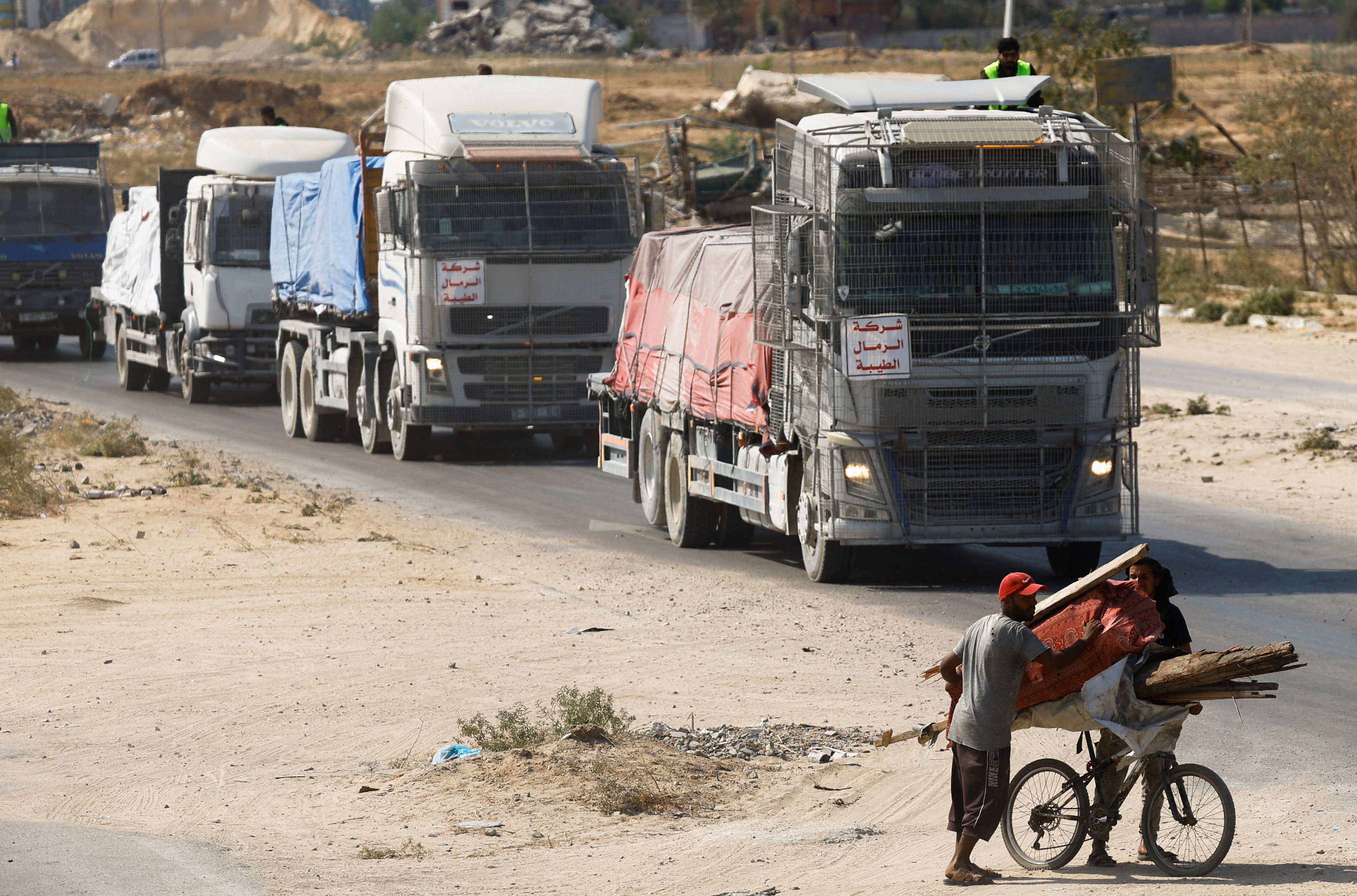 Trucks carry aid for Palestinians in Khan Younis.