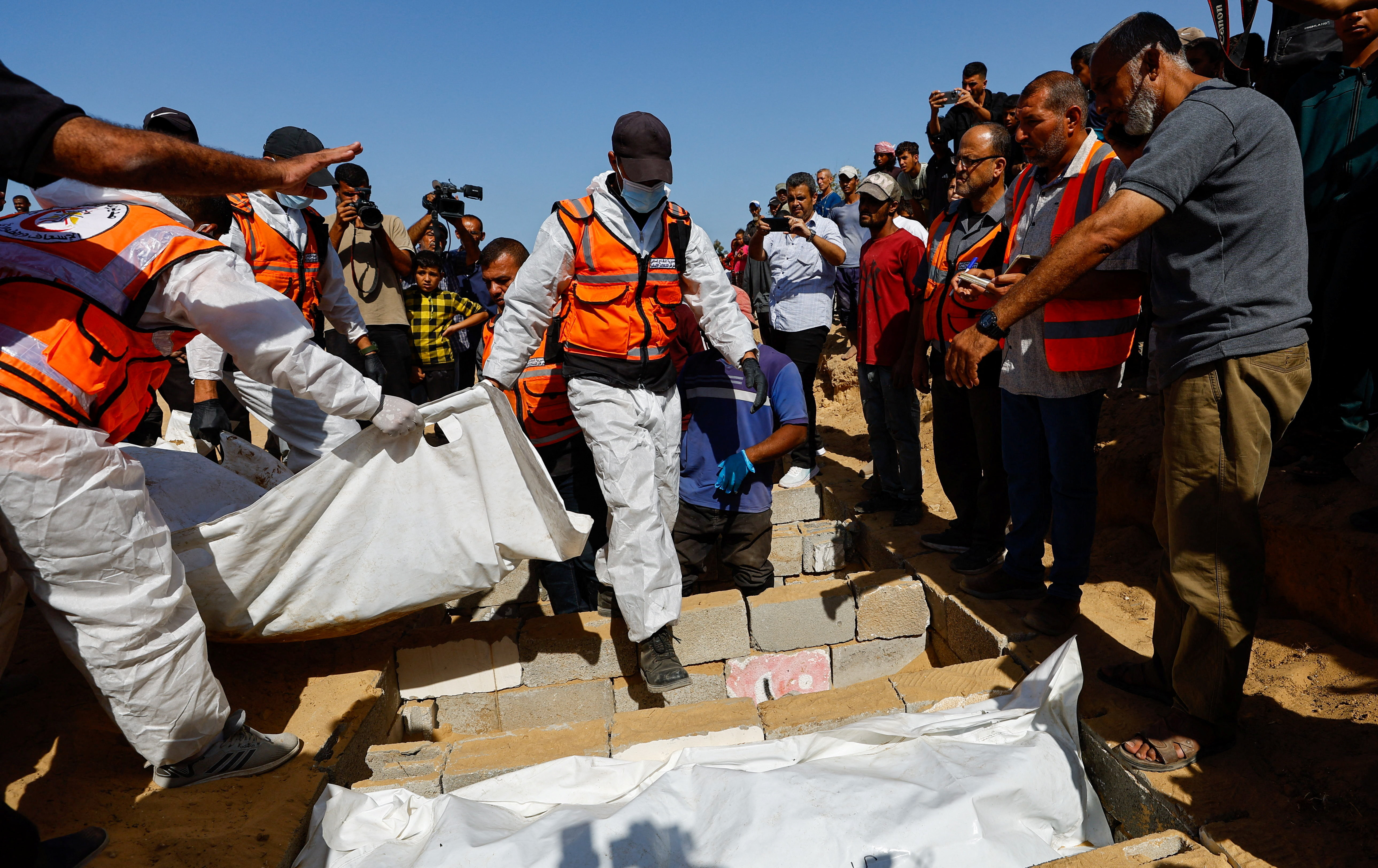 Families mourn as mass burial held for unidentified Palestinians in Gaza