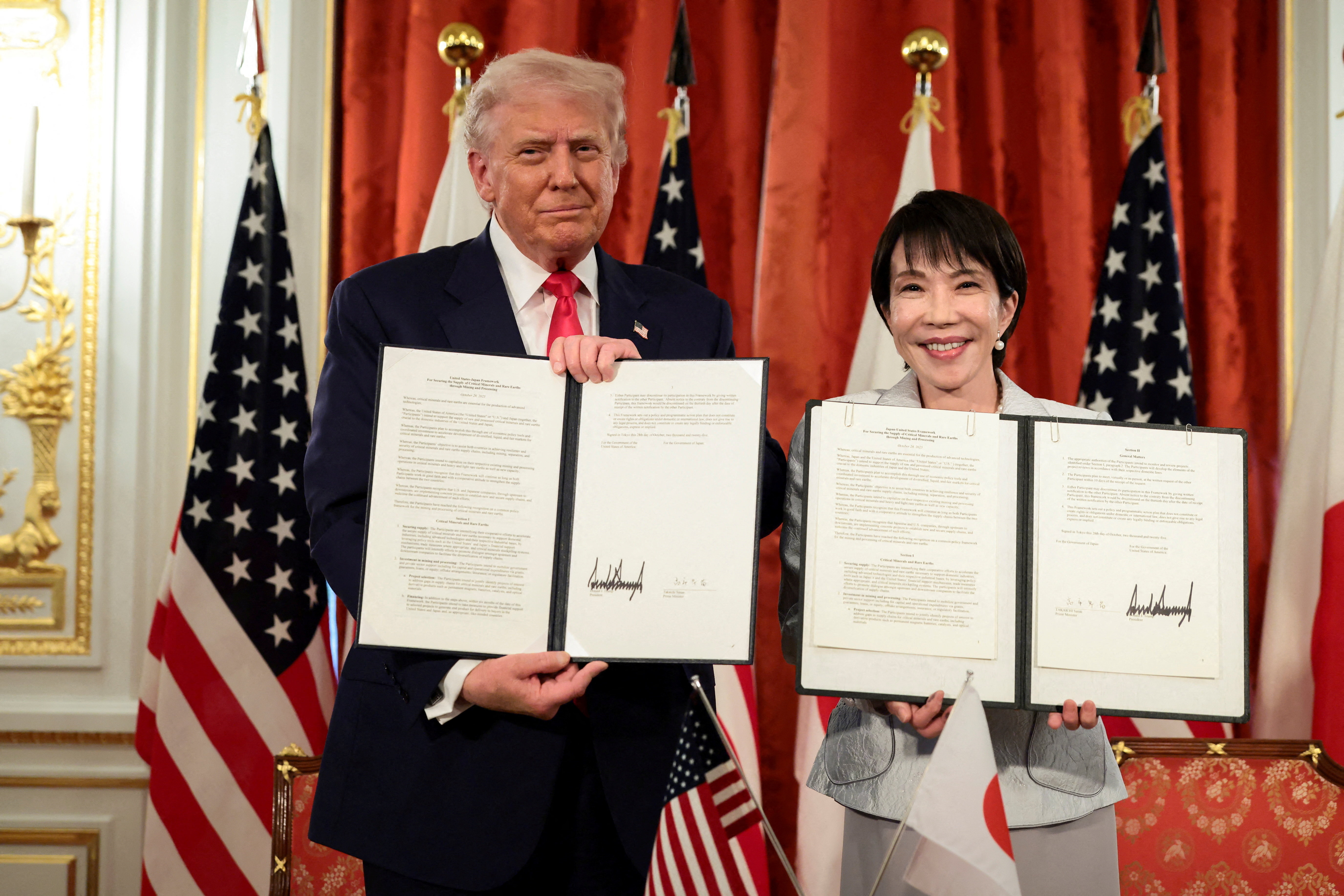 U.S. President Donald Trump and Japanese Prime Minister Sanae Takaichi hold up signed documents regarding securing the supply of critical minerals and rare earths, at a bilateral meeting at Akasaka Palace in Tokyo, Japan, October 28, 2025.