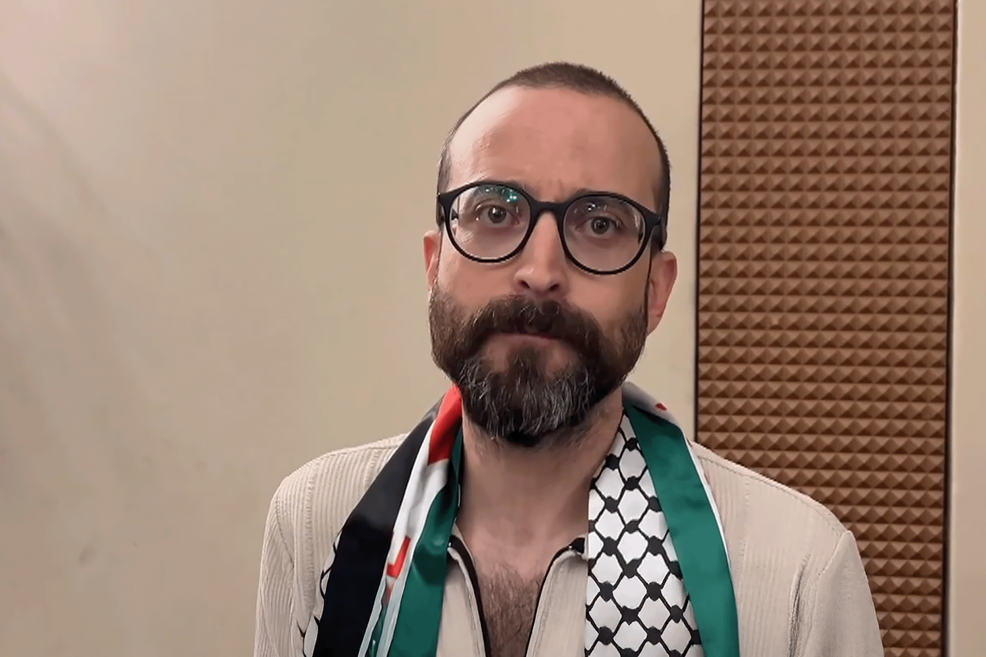 Freed prisoner and novelist Basem Khandakji wears a Palestinian scarf.