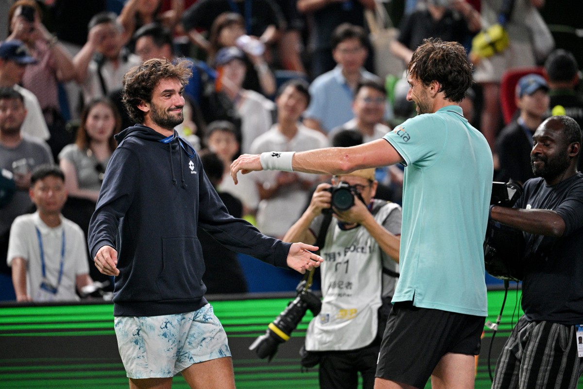 France's Arthur Rinderknech celebrates with Monacos Valentin Vacherot after winning against Russia's Daniil Medvedev at the end of their mens singles semi-final match during the Shanghai Masters tennis tournament in Shanghai on October 11, 2025. (Photo by Hector RETAMAL / AFP)