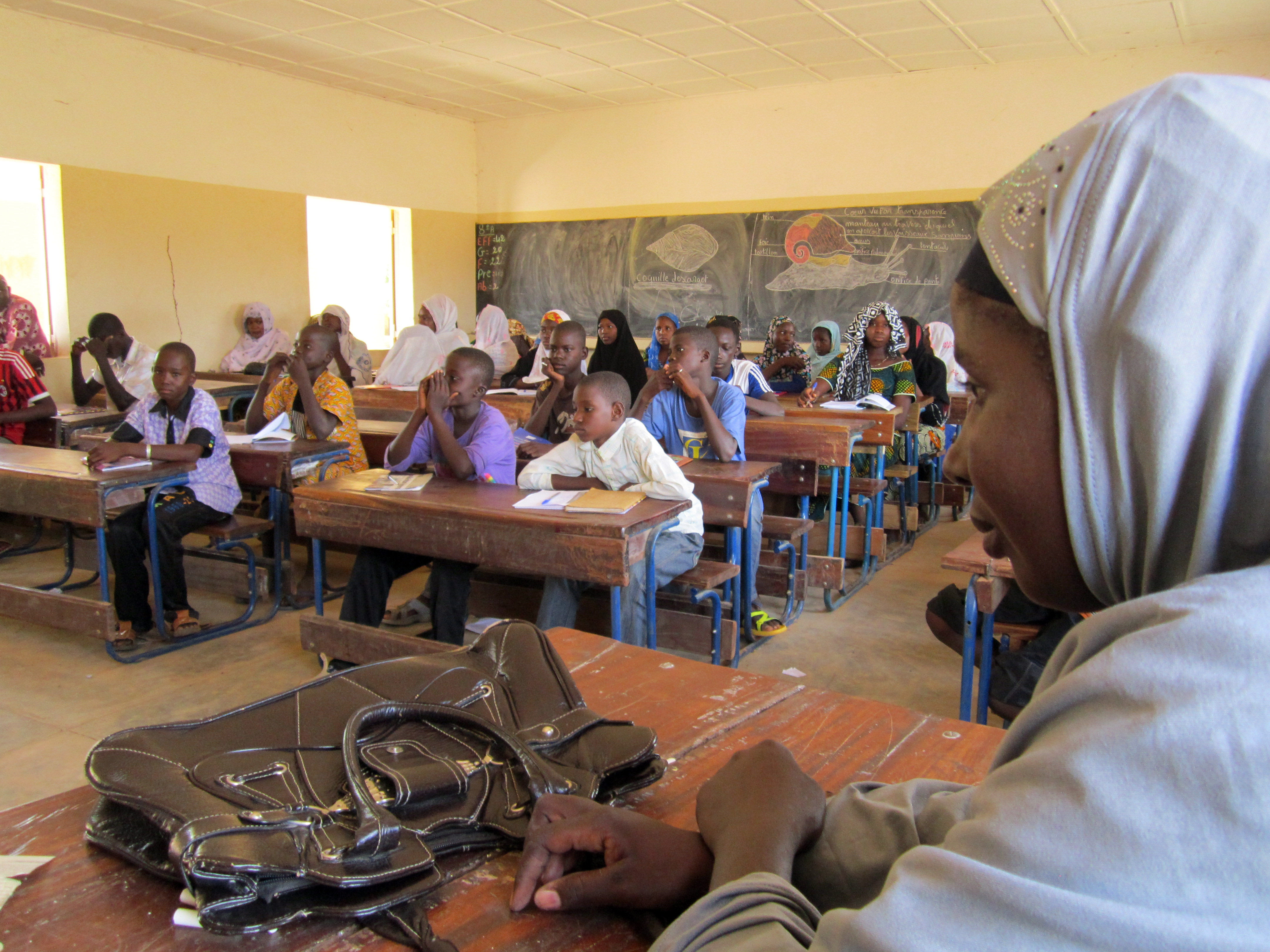 Schoolchildren listen to a teacher during class.