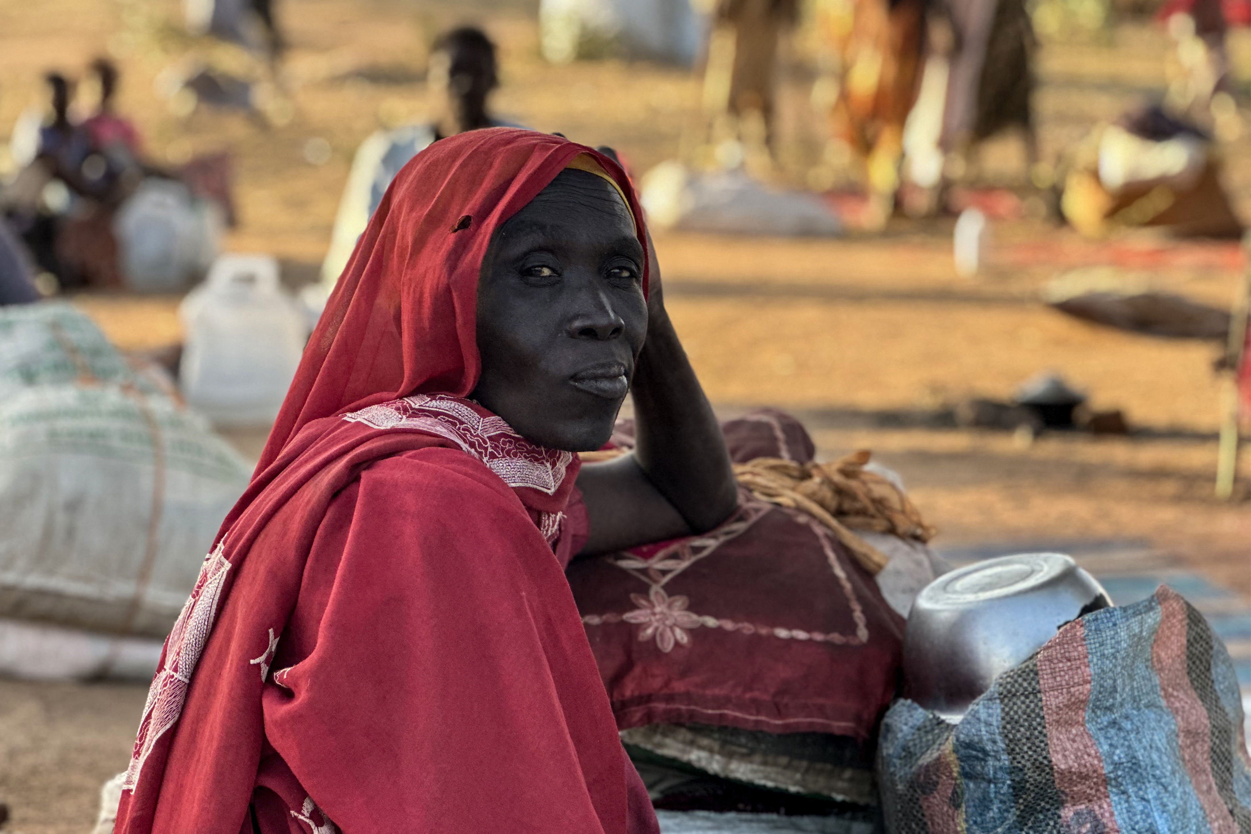 A displaced Sudanese woman who fled El-Fasher after the city fell to the Rapid Support Forces (RSF), rests in the town of Tawila in war-torn Sudan's western Darfur region on October 28, 2025.