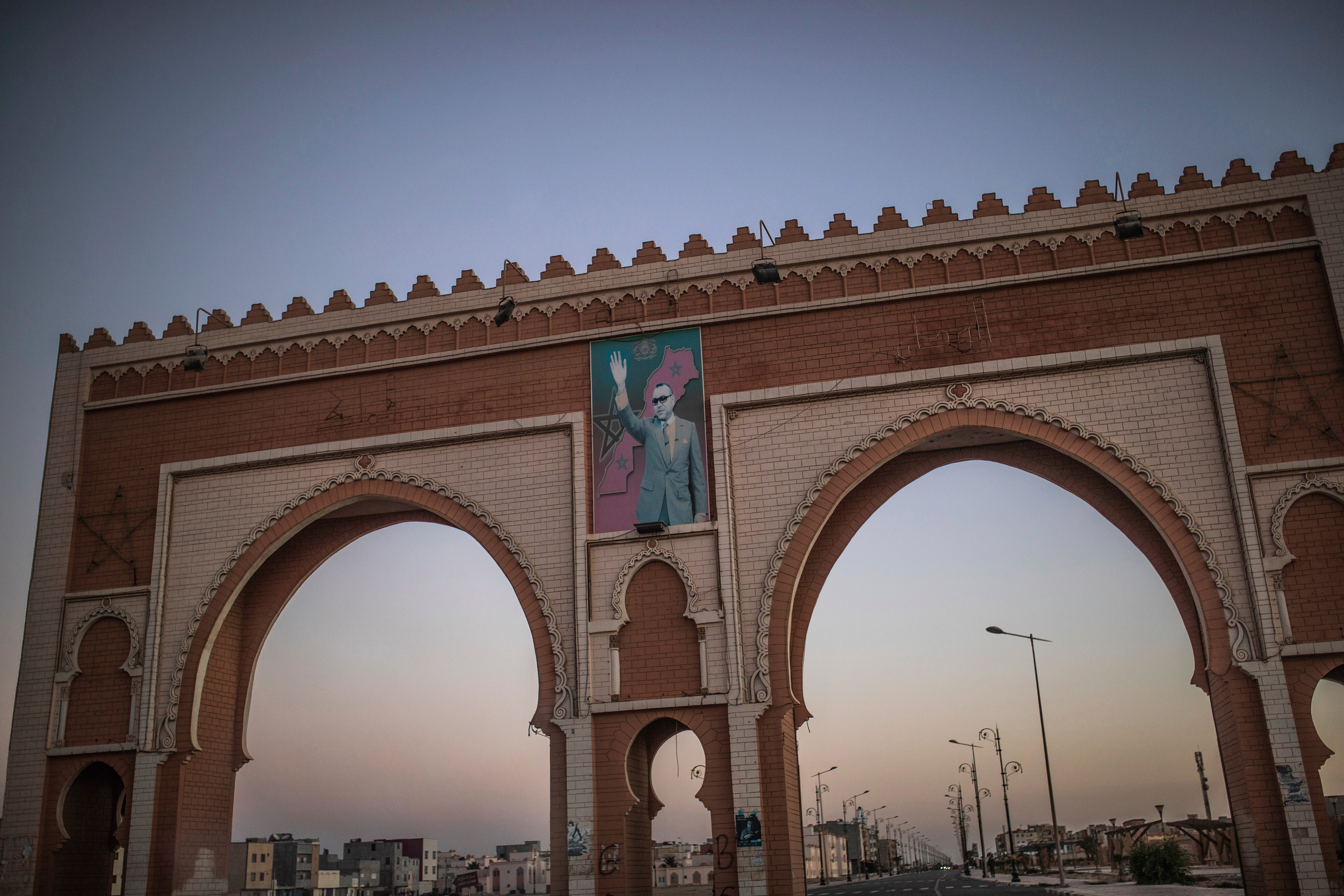FILE - An archway in the entrance of Dakhla carries an image of Morocco's King Mohammed VI, in Western Sahara, on Dec. 21, 2020. (AP Photo/Mosa'ab Elshamy, File)