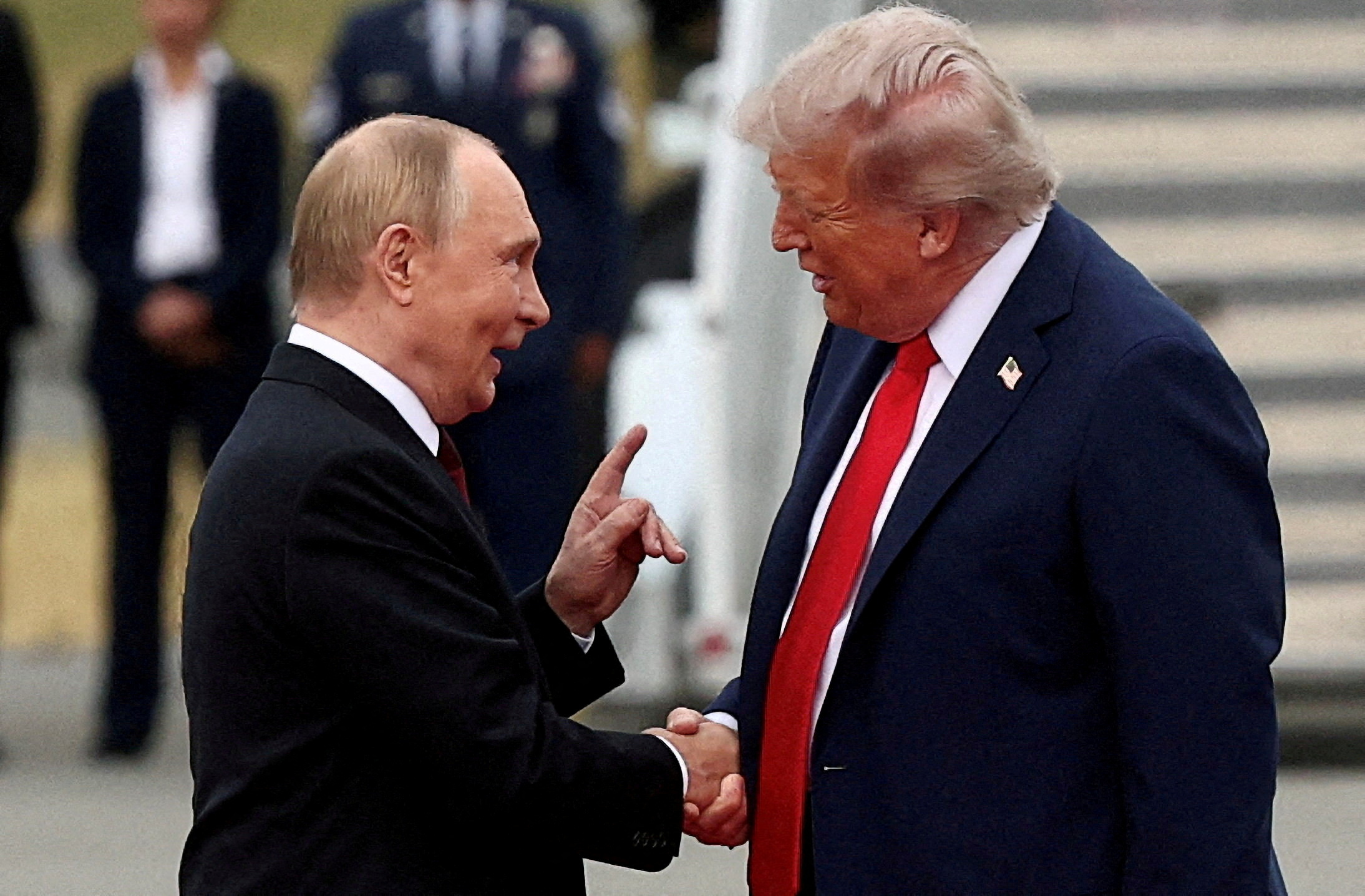 FILE PHOTO: U.S. President Donald Trump shakes hand with Russian President Vladimir Putin, as they meet to negotiate for an end to the war in Ukraine, at Joint Base Elmendorf-Richardson in Anchorage, Alaska, U.S., August 15, 2025. REUTERS/Kevin Lamarque/File Photo