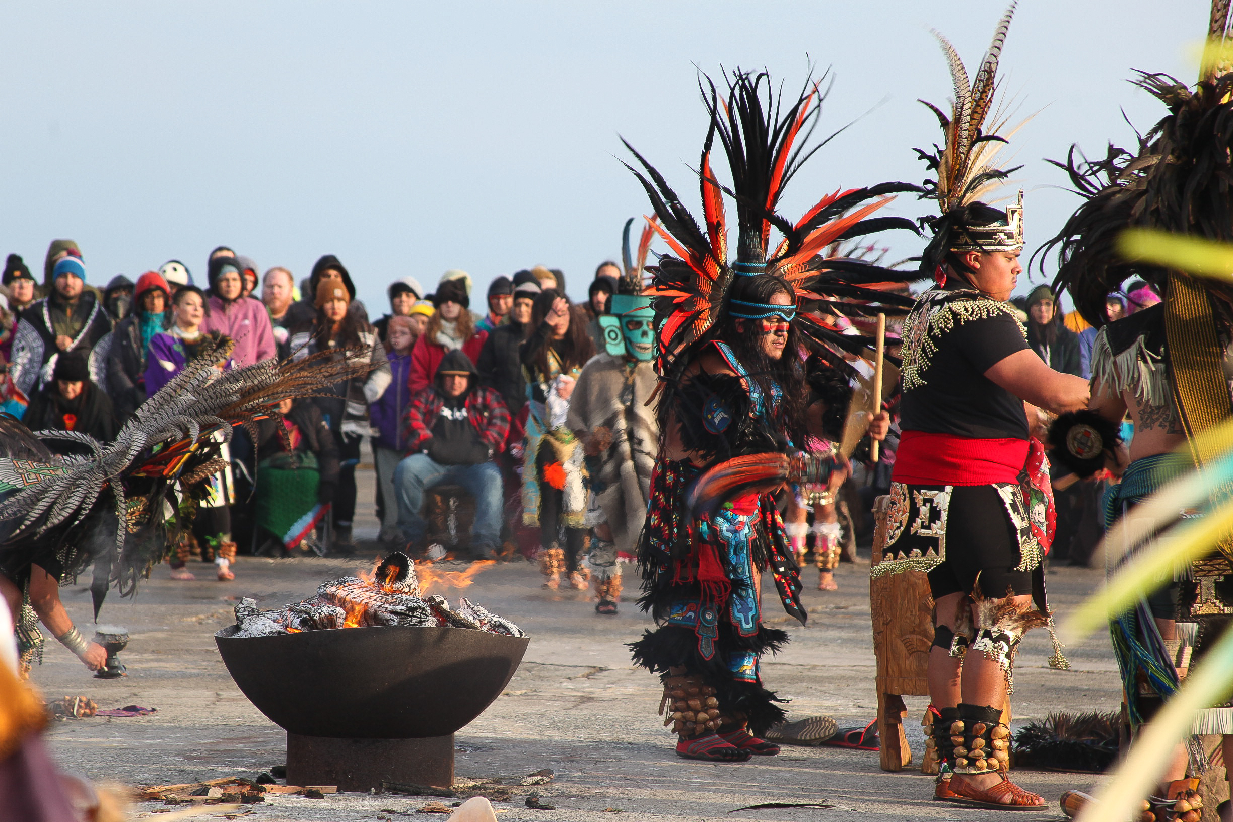 Indigenous dancers and supporters gather around a sacred fire on Alcatraz Island