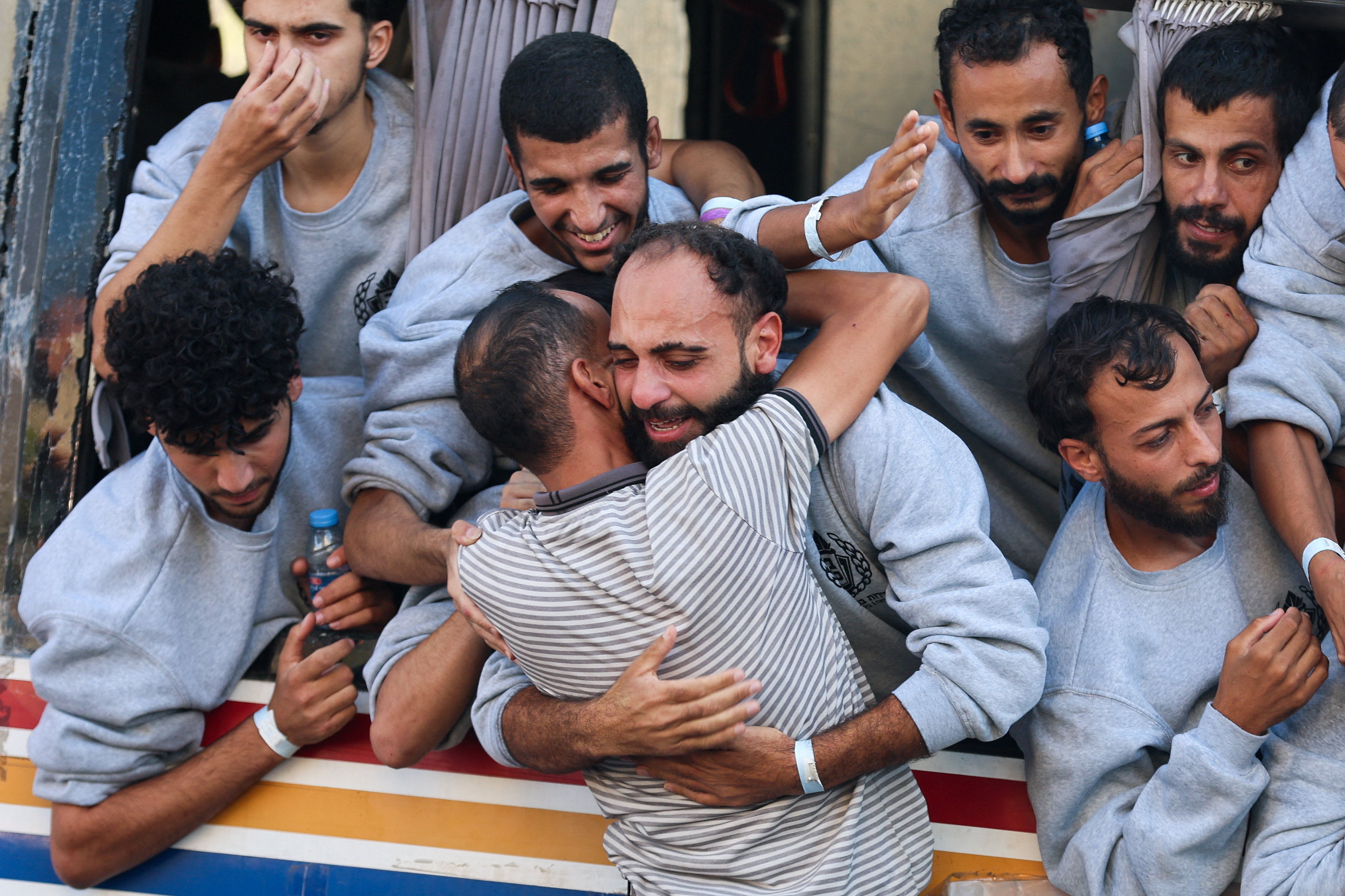 A freed Palestinian prisoner released by Israel as part of the ceasefire deal between Hamas and Israel, hugs a family member, in Khan Younis in the southern Gaza Strip, October 13, 2025 [Ramadan Abed/Reuters]
