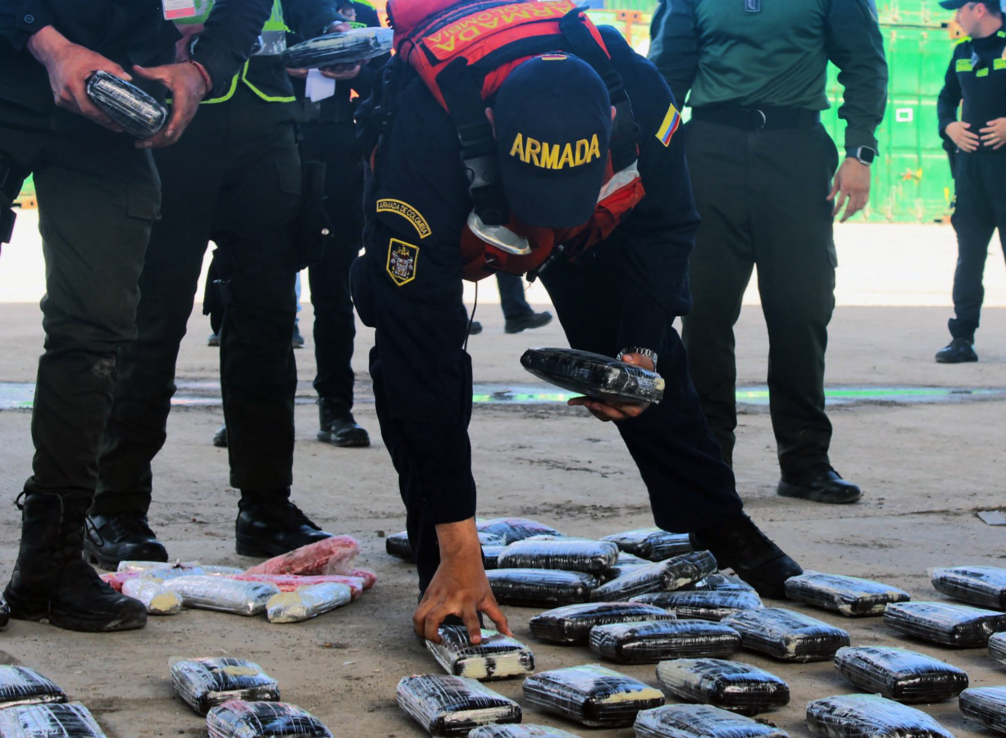 This handout picture released by the Colombian National Navy shows Navy officers arranging packs of cocaine after a seizure in Tumaco, Nariño departament, southeast Colombia on December 11, 2023. The Colombian Navy announced that in the last month and a half, 195 tons of cocaine were confiscated within a joint operation with other countries. (Photo by Handout / COLOMBIA'S NAVY / AFP) / RESTRICTED TO EDITORIAL USE - MANDATORY CREDIT "AFP PHOTO / COLOMBIA'S NAVY " - NO MARKETING NO ADVERTISING CAMPAIGNS - DISTRIBUTED AS A SERVICE TO CLIENTS