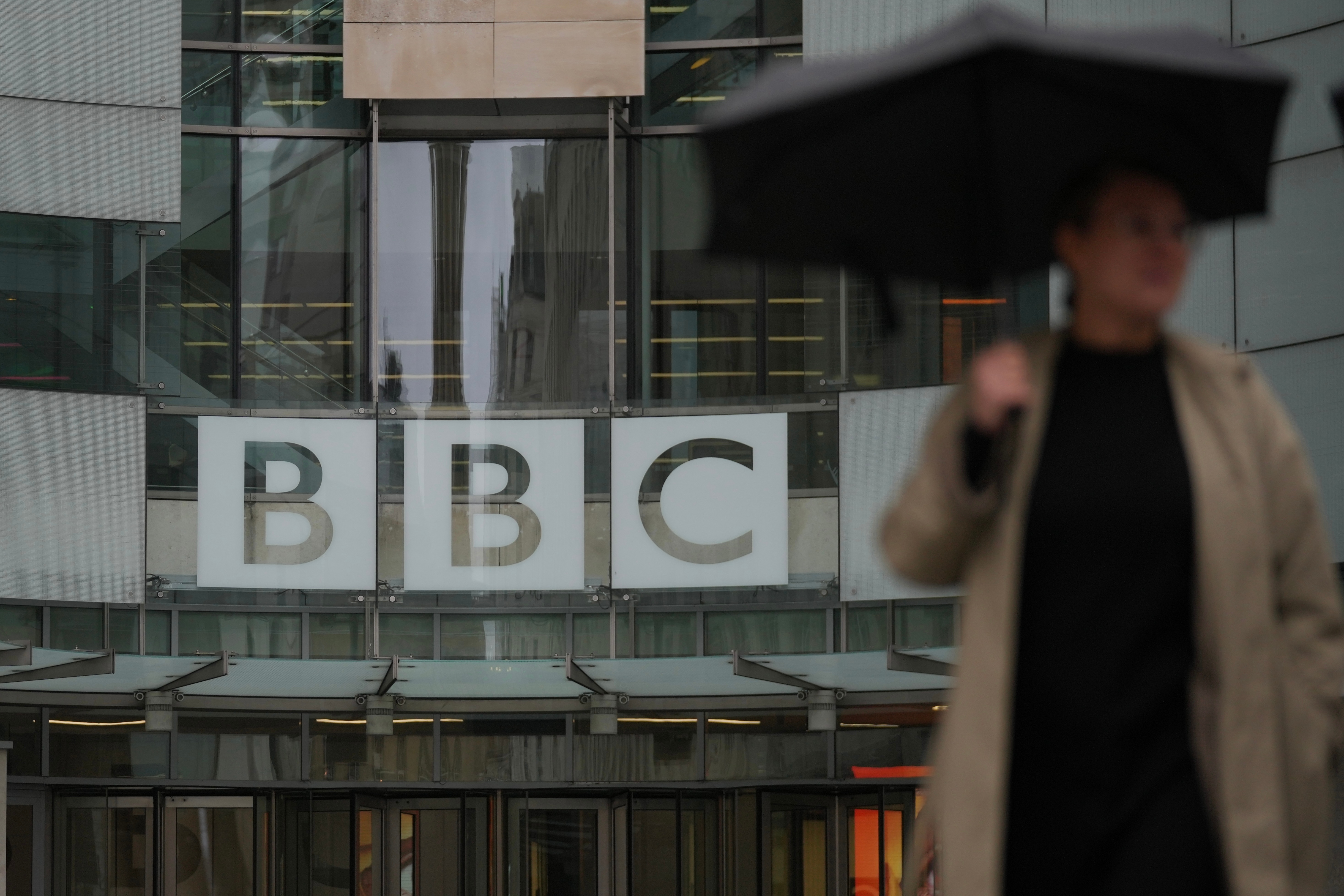 A man walks outside the BBC headquarters in London, UK.