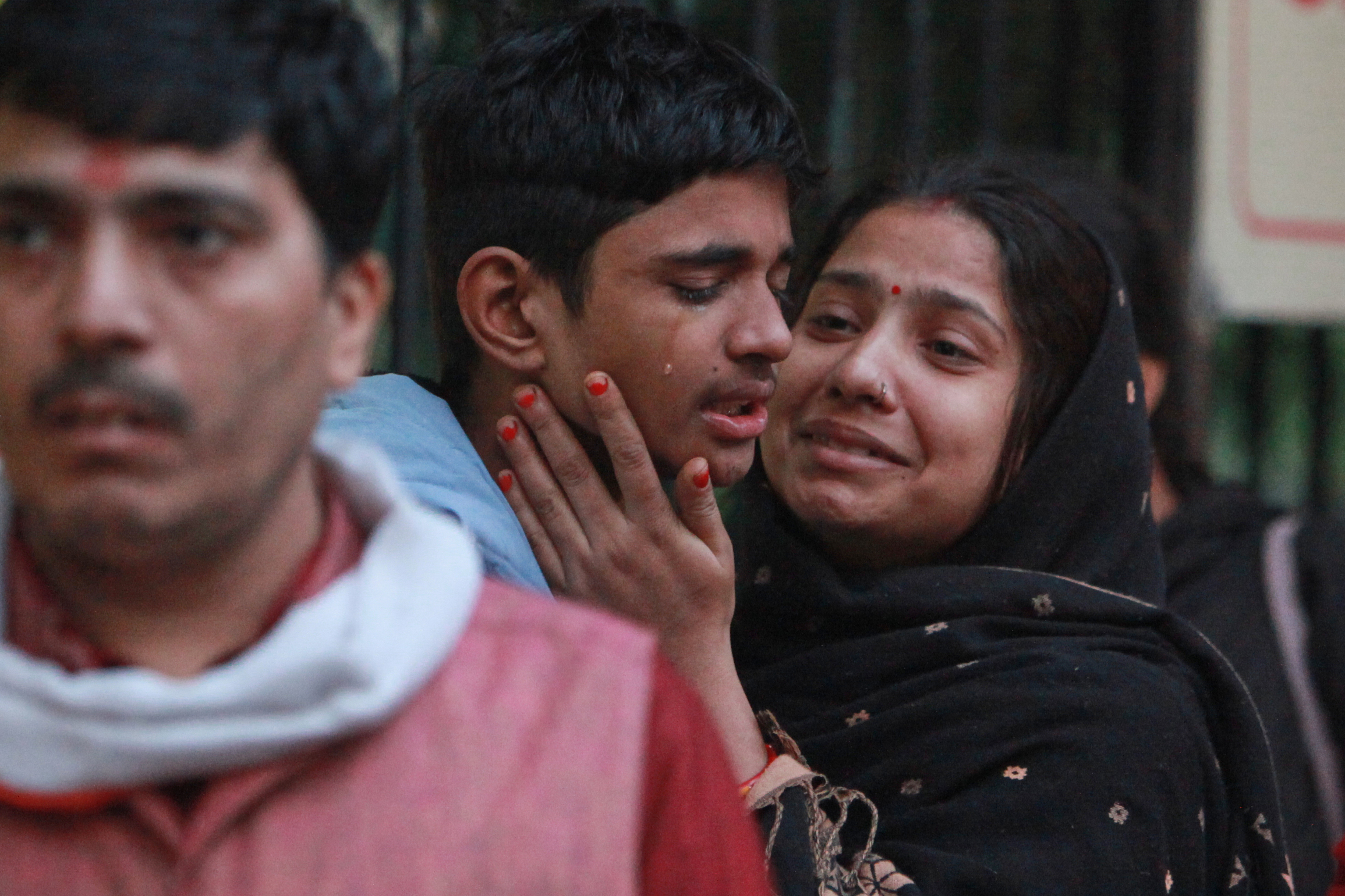 Family members of a car explosion victim grieve as they arrive at a hospital mortuary to collect the body in New Delhi, India, Tuesday, Nov. 11, 2025. (AP Photo)