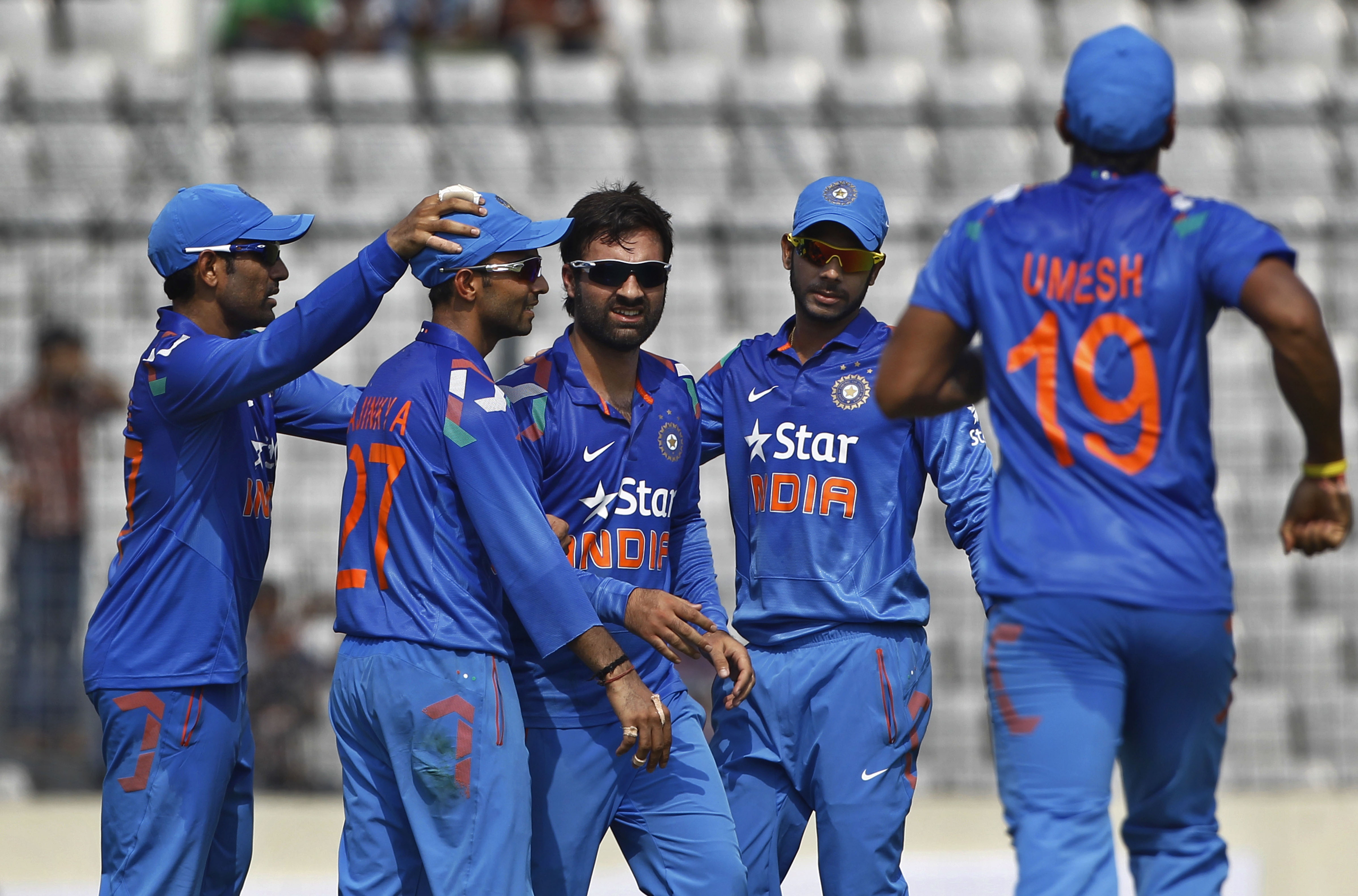 India's Parvez Rasool, center, celebrates with his teammates the wicket of Bangladeshs captain Mushfiqur Rahim during their first one-day International cricket match in Dhaka, Bangladesh, Sunday, June 15, 2014. (AP Photo/A.M. Ahad)