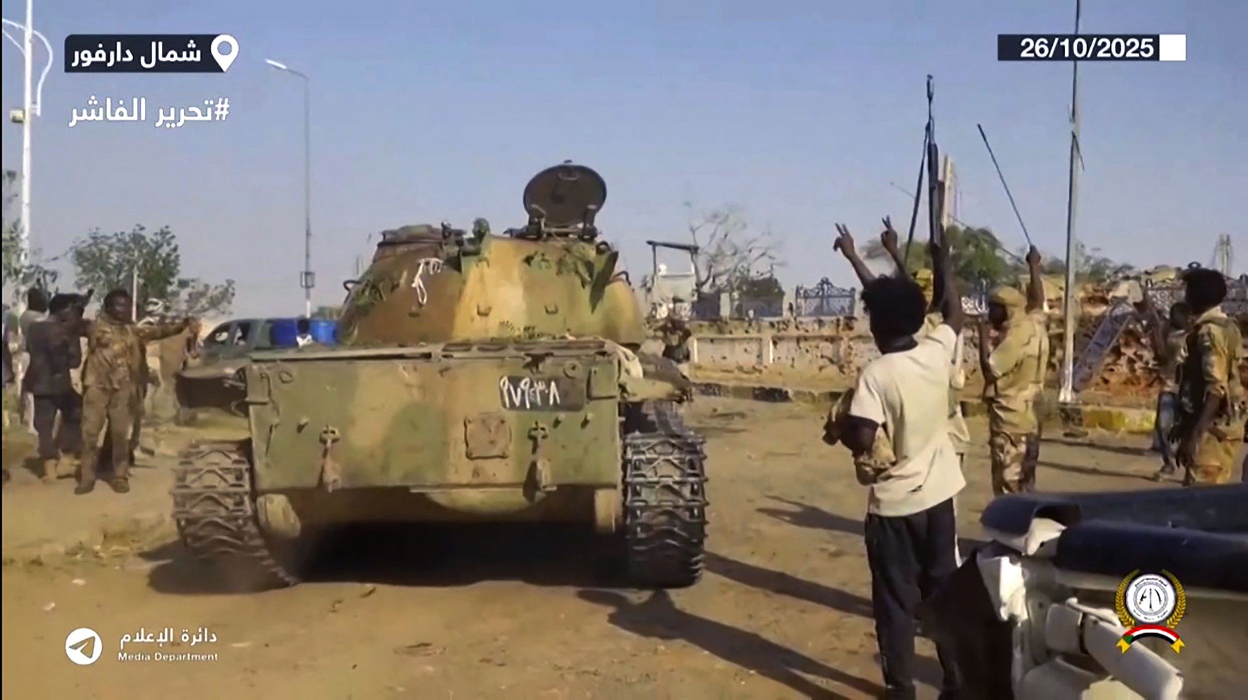 TOPSHOT - This image grab taken from handout video footage released on Sudan's paramilitary Rapid Support Forces RSF fighters celebrating in the streets of El-Fasher in Sudan's Darfur.