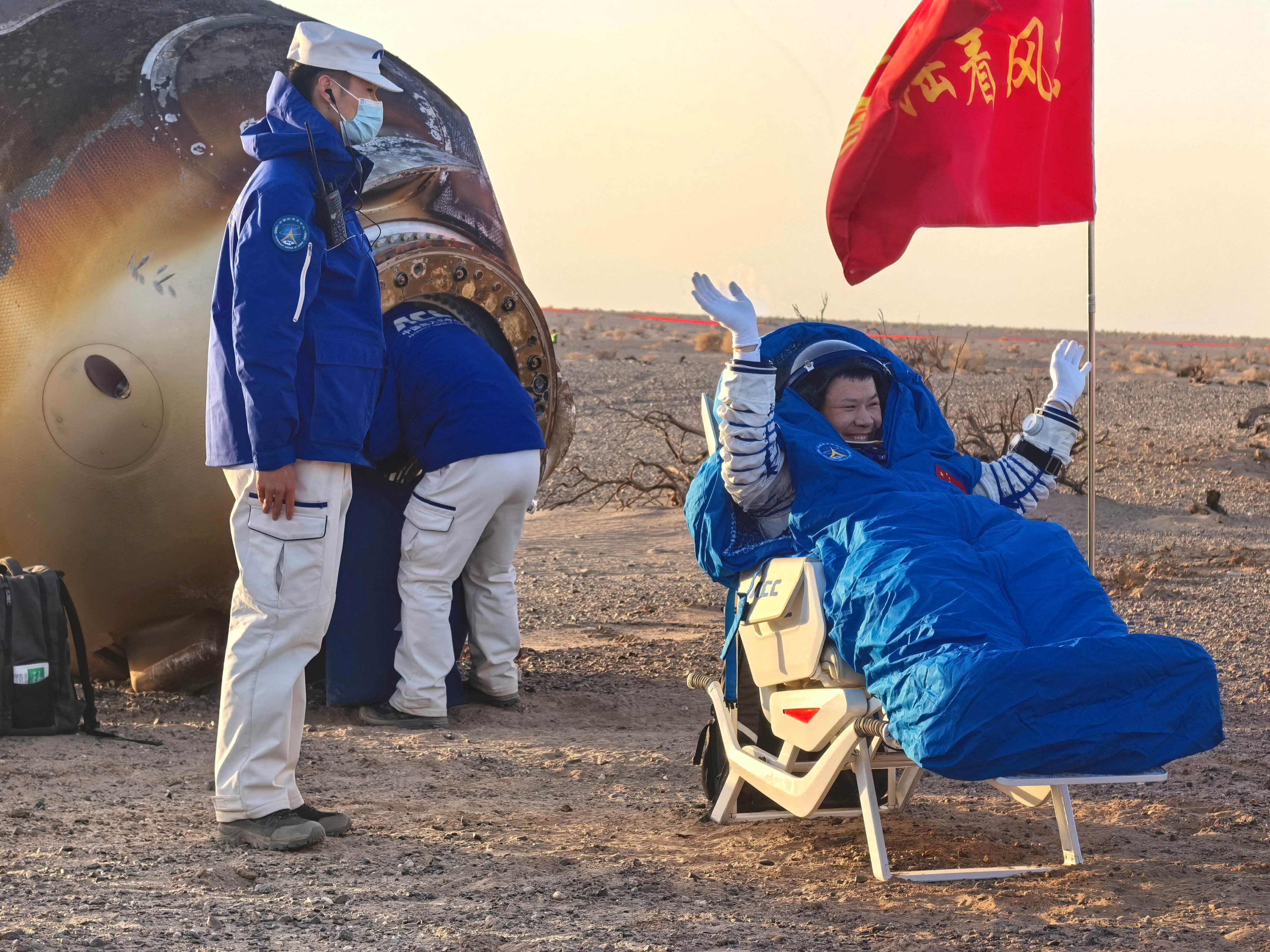 Astronaut Wang Jie of Shenzhou-20 crew waves outside the return capsule of the crewed spacecraft