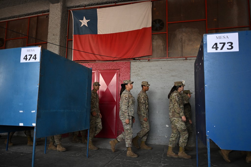 Army officers patrol a polling station at Chile's National Stadium ahead of the second round of the presidential election in Santiago