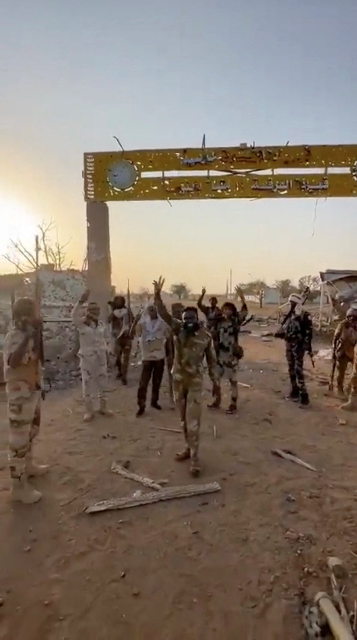 Members of Sudan's paramilitary Rapid Support Forces (RSF) stand in front of the main gate of the 22nd SAF Infantry Division, in Babanusa, Sudan, in this screengrab obtained from a social media video released December 1, 2025. Social Media/via REUTERS. THIS IMAGE HAS BEEN SUPPLIED BY A THIRD PARTY. NO RESALES. NO ARCHIVES.