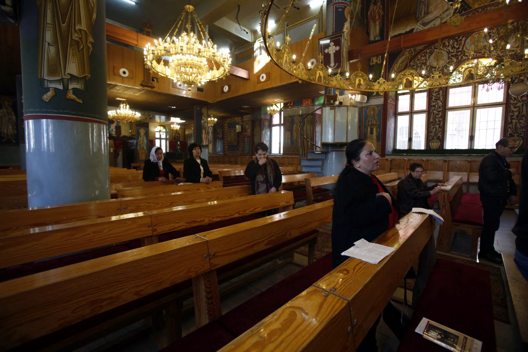 Worshippers attend mass at an Orthodox church in Beit Sahour near the West Bank city of Bethlehem on March 8, 2020, after the city came under lockdown [File: Musa Al Shaer/AFP]