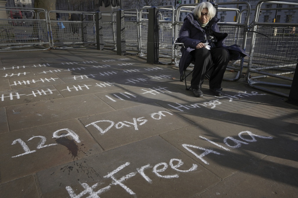 Abd El-Fattah's mother Leila Soueif sits outside of Downing Street calling for her son's release