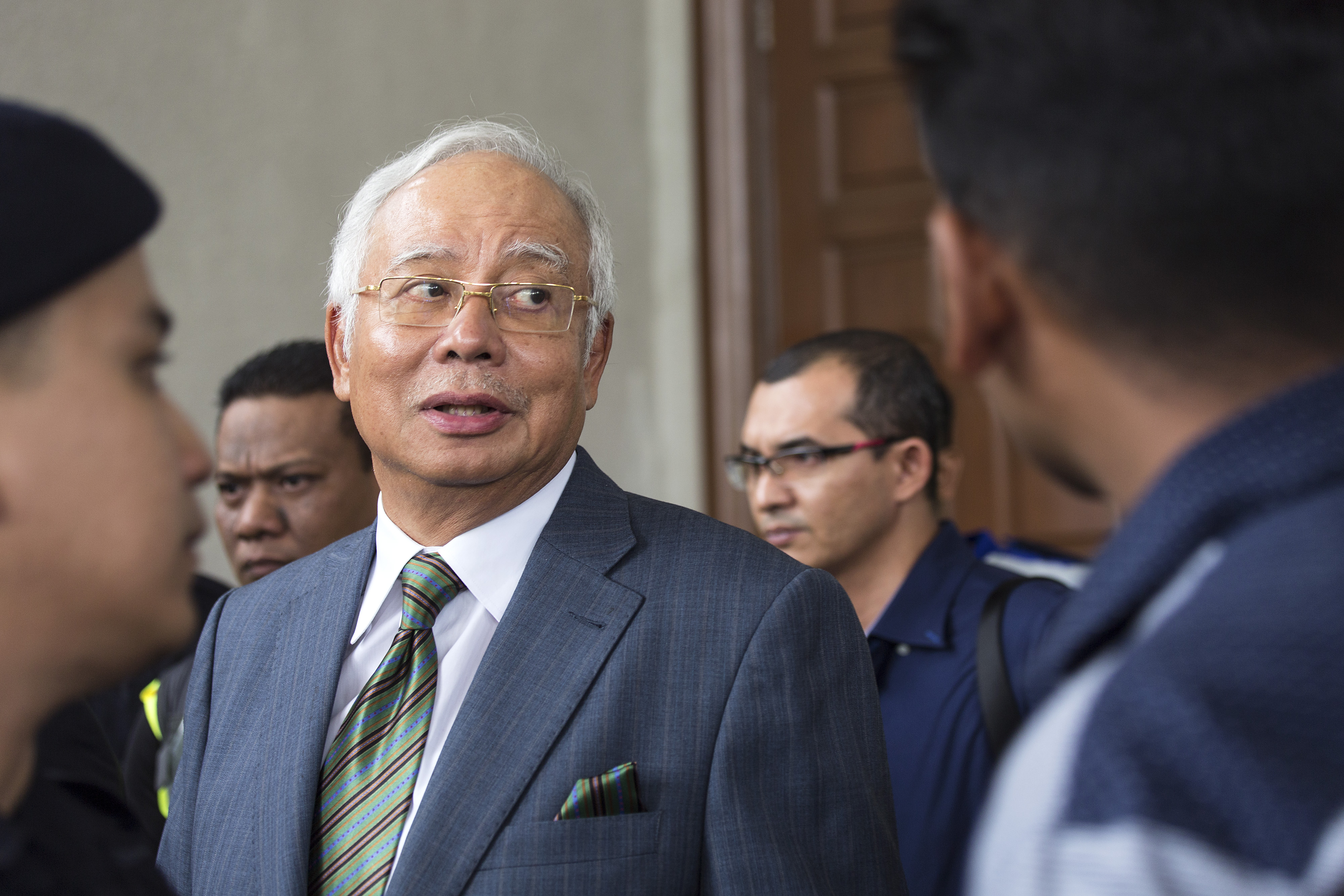 KUALA LUMPUR, MALAYSIA - AUGUST 08: Malaysia's former Prime Minister Najib Razak exits the Kuala Lumpur High Court on August 8, 2018 in Kuala Lumpur, Malaysia. Malaysia's former Prime Minister Najib Razak was charged with three counts of money laundering on Wednesday after being hit with new charges in connection with a multi-billion-dollar scandal at state fund 1Malaysia Development Berhad (1MDB) that contributed to his shock election defeat by 93-year-old veteran politician Mahathir Mohamad in May. Najib faces up to 15 years in jail for each charge as he pleaded not guilty to the charges and was released on bail.(Photo by Ore Huiying/Getty Images)