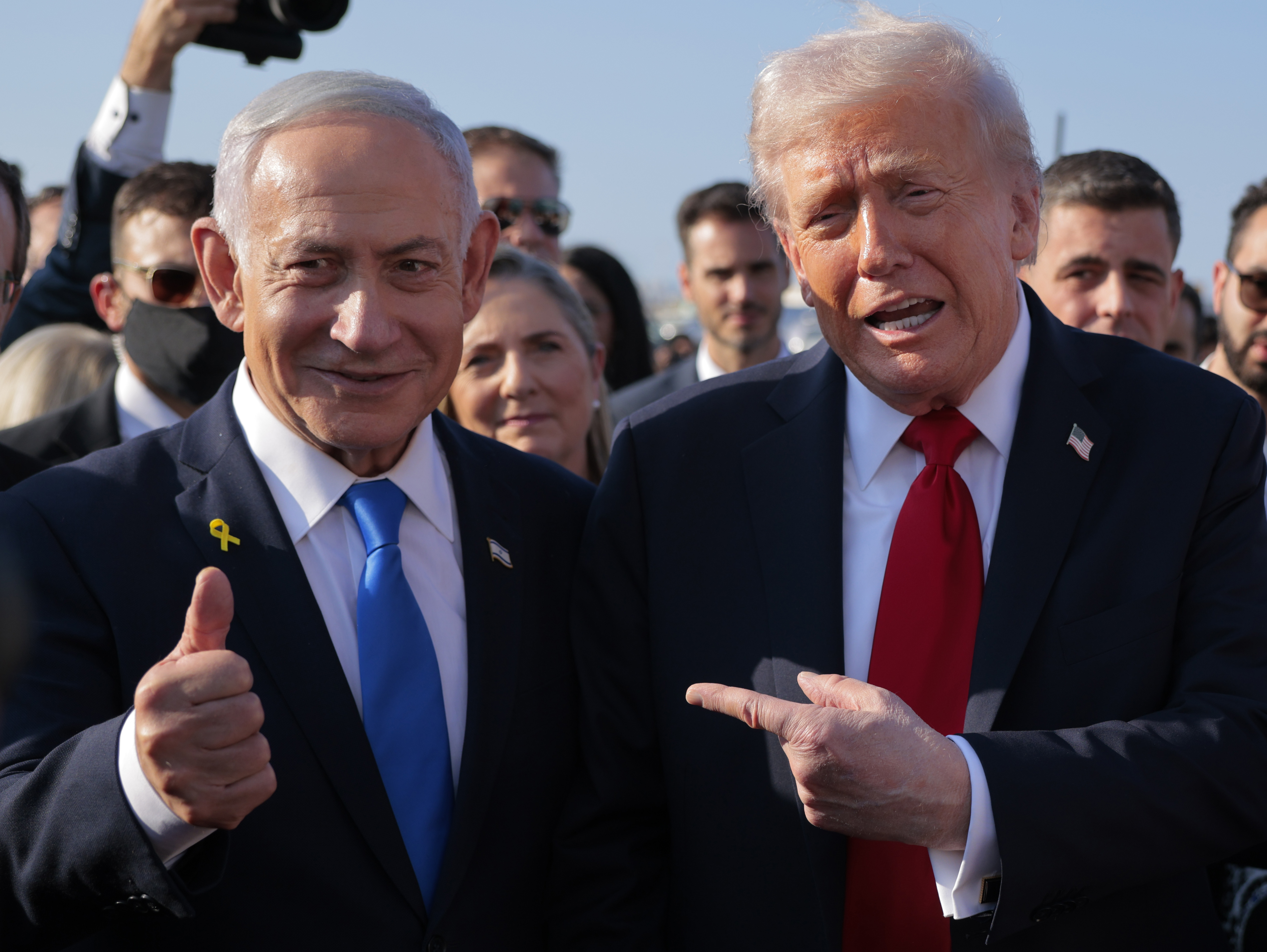 TEL AVIV, ISRAEL - OCTOBER 13: U.S. President Donald Trump speaks to Israeli Prime Minister Benjamin Netanyahu at Ben Gurion International Airport before boarding his plane to Sharm El-Sheikh, on October 13, 2025 in Tel Aviv, Israel. President Trump is visiting the country hours after Hamas released the remaining Israeli hostages captured on Oct. 7, 2023, part of a US-brokered ceasefire deal to end the war in Gaza. (Photo by Chip Somodevilla/Getty Images)