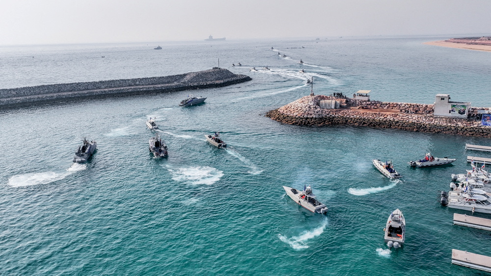 Speedboats moving in the sea near wavebreakers.