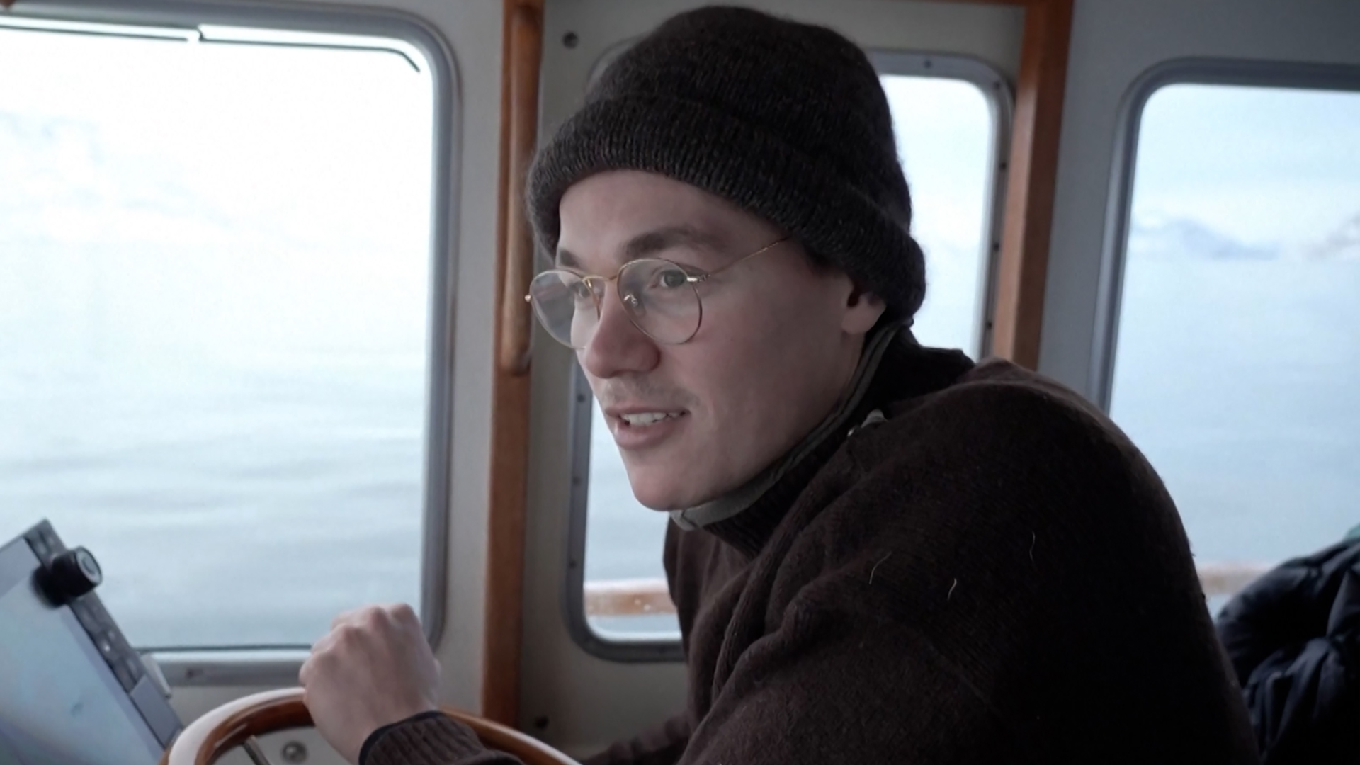 A Greenlandic man pilots a boat in the Nuuk fjord on January 21, 2026. [Screenshot via Reuters]