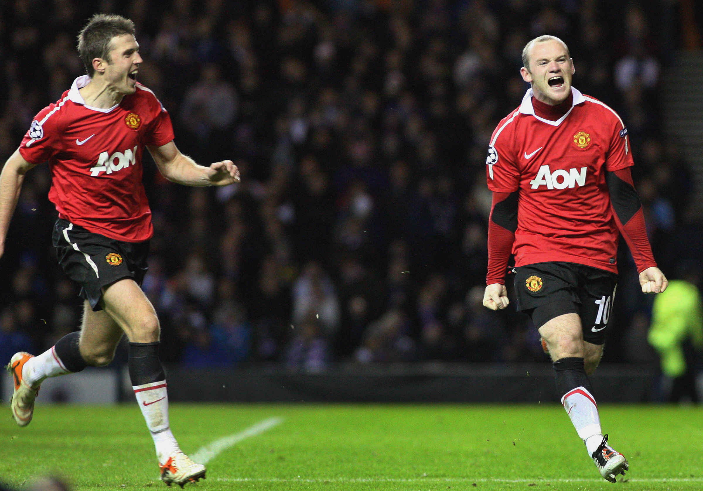 Michael Carrick and Wayne Rooney in action.