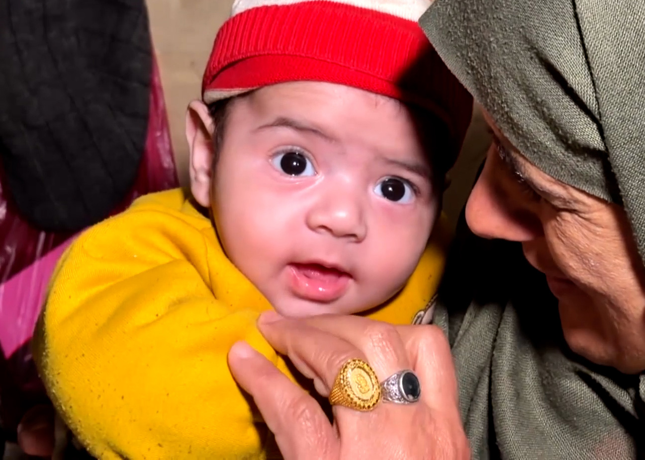Hamza Al-Rubaie in the arms of his aunt in Gaza City, Gaza. [Al Jazeera]