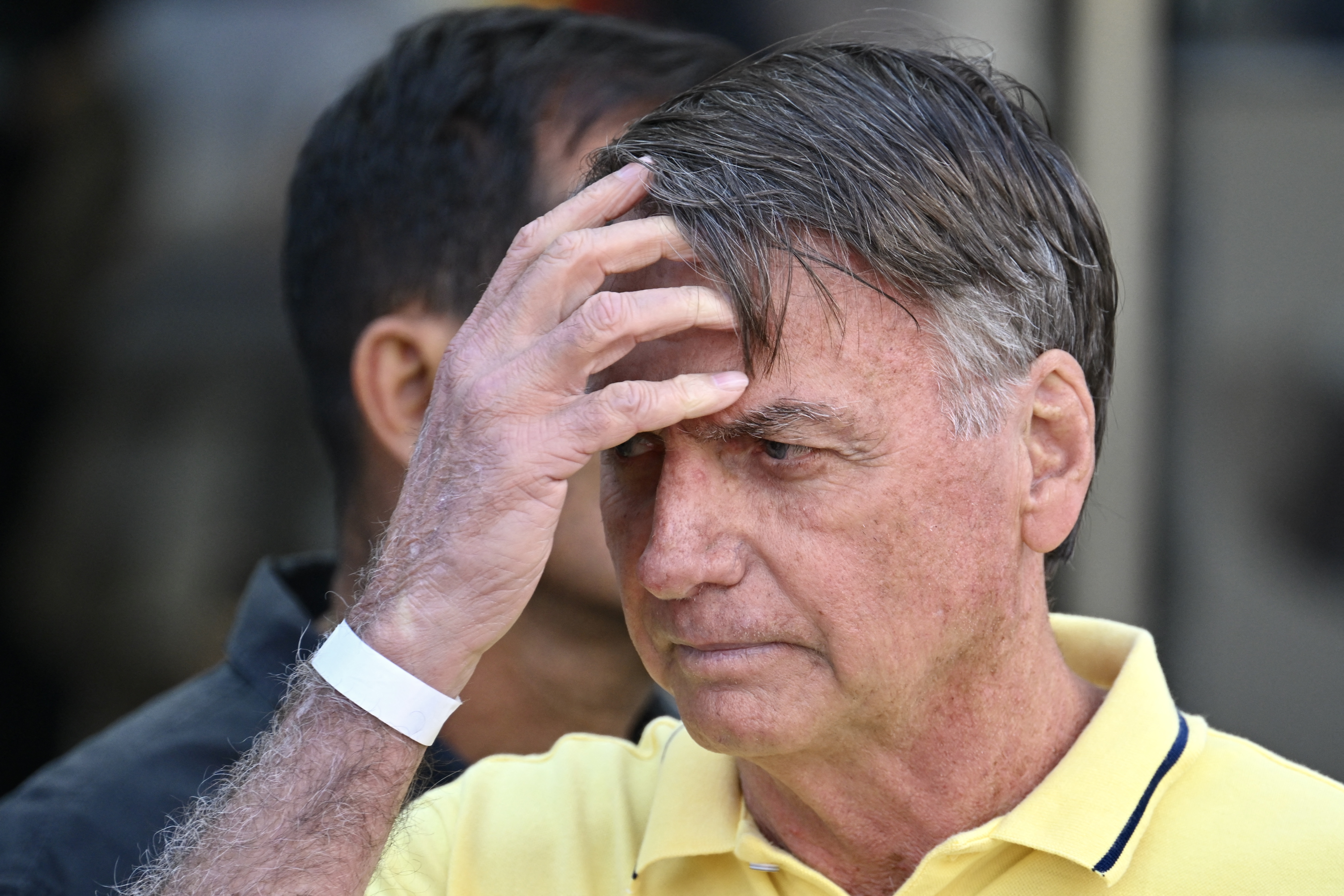 (FILES) Former Brazilian President Jair Bolsonaro gestures after taking medical tests at DF Star hospital in Brasilia on August 16, 2025.