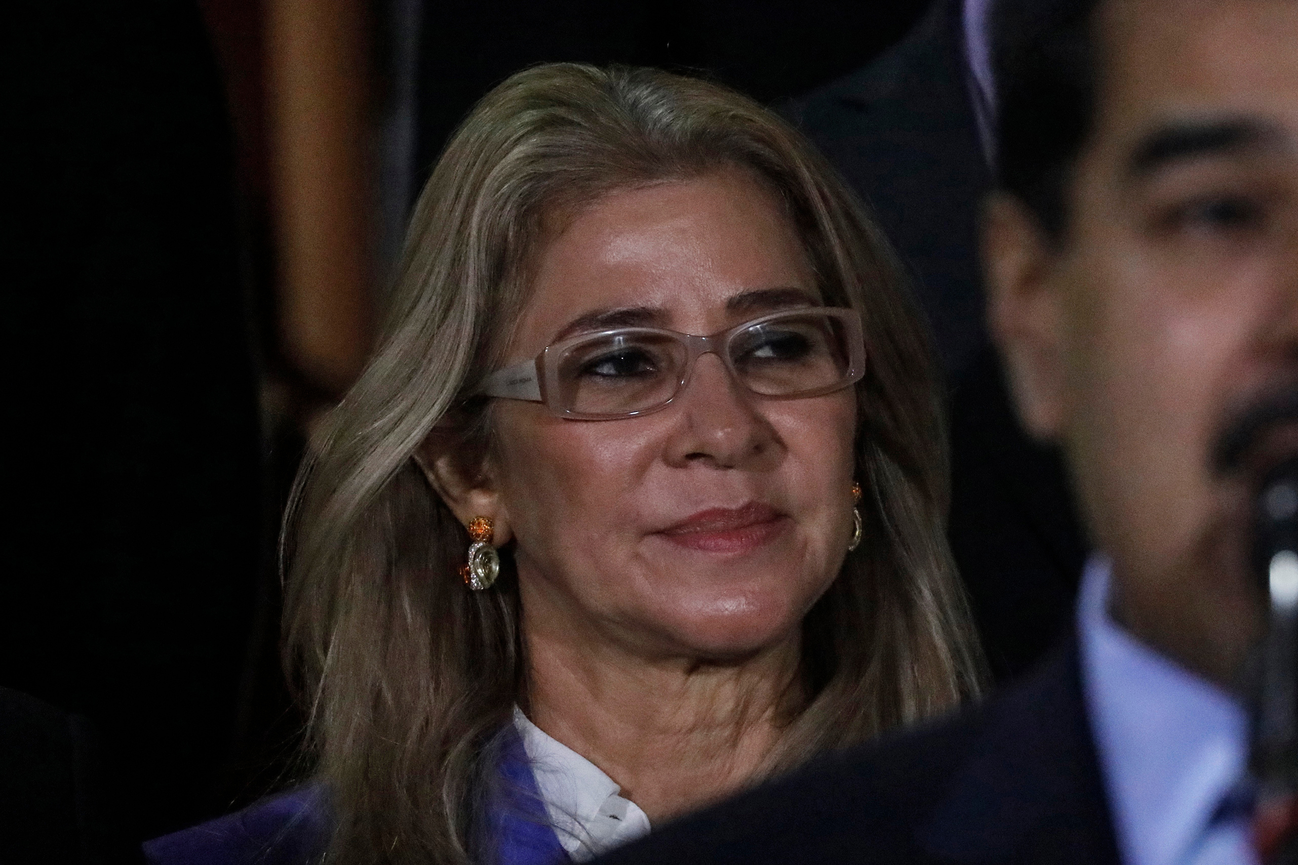 First lady Cilia Flores stands behind her husband Venezuela's President Nicolas Maduro during a press conference