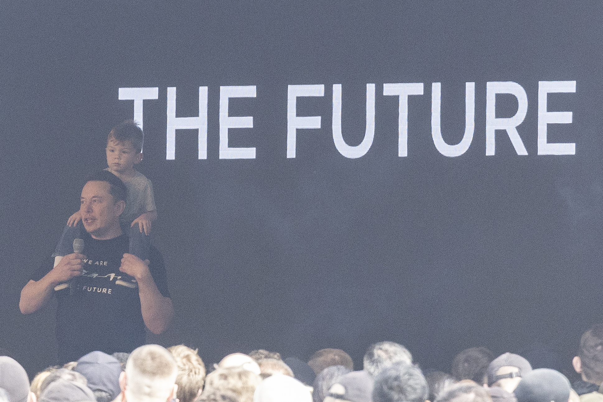GRUENHEIDE, GERMANY - MARCH 13: Elon Musk, Tesla CEO talks to employees as he holds his son X Æ A-XII during a visit at the company's electric car plant Tesla Gigafactory on March 13, 2024 near Gruenheide, Germany. Musk is visiting the plant following an arson attack on March 4 on a nearby power transmission tower that left the factory without electricity until March 11. A leftist activists group called "Vulkan Group" ("Vulkangruppe") has taken responsibility for the attack. (Photo by Maja Hitij/Getty Images)