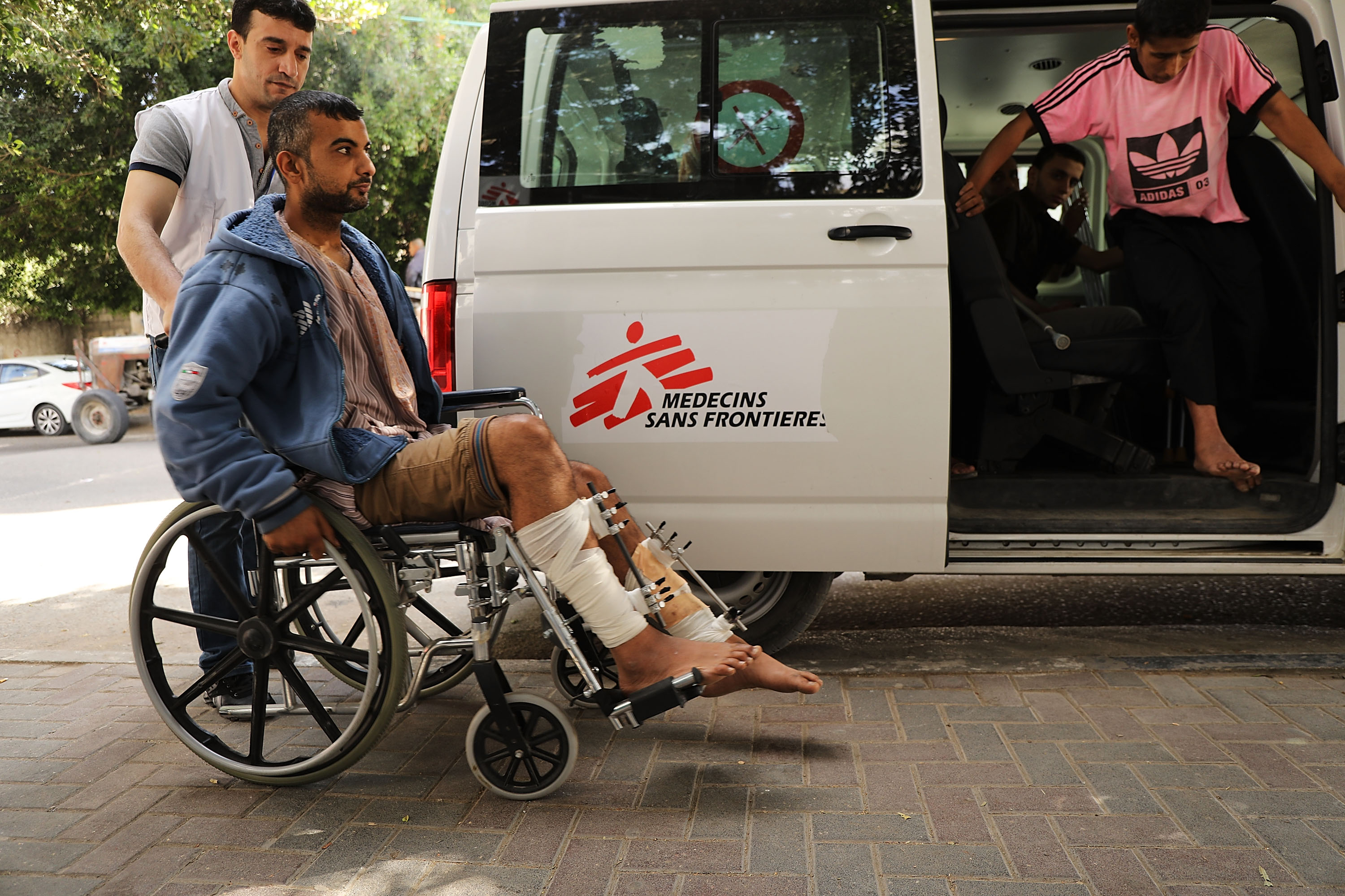 GAZA CITY, GAZA - MAY 13: A man who was shot in his legs during protests at the Gaza/Israel border fence enters a medical clinic operated by Medecins Sans Frontieres/Doctors Without Borders (MSF) on May 13, 2018 in Gaza City, Gaza. The international humanitarian medical non-governmental organisation (NGO) has treated over 700 gunshot wounds alone since the protests against Israel started last month. Tensions are high along the Gaza-Israel border following more than a month of weekly mass protests near the fence that has left 40 Palestinian protesters killed and over 1,700 wounded by Israeli army fire. Gaza's Hamas rulers have vowed that the marches will continue until the decade-old Israeli blockade of the territory by is lifted. Anticipation is building to a massive protest on May 15, the day Palestinians mark the "nakba" or catastrophe, to commemorate the anniversary of their mass uprooting during the 1948 war over Israel's creation. (Photo by Spencer Platt/Getty Images)