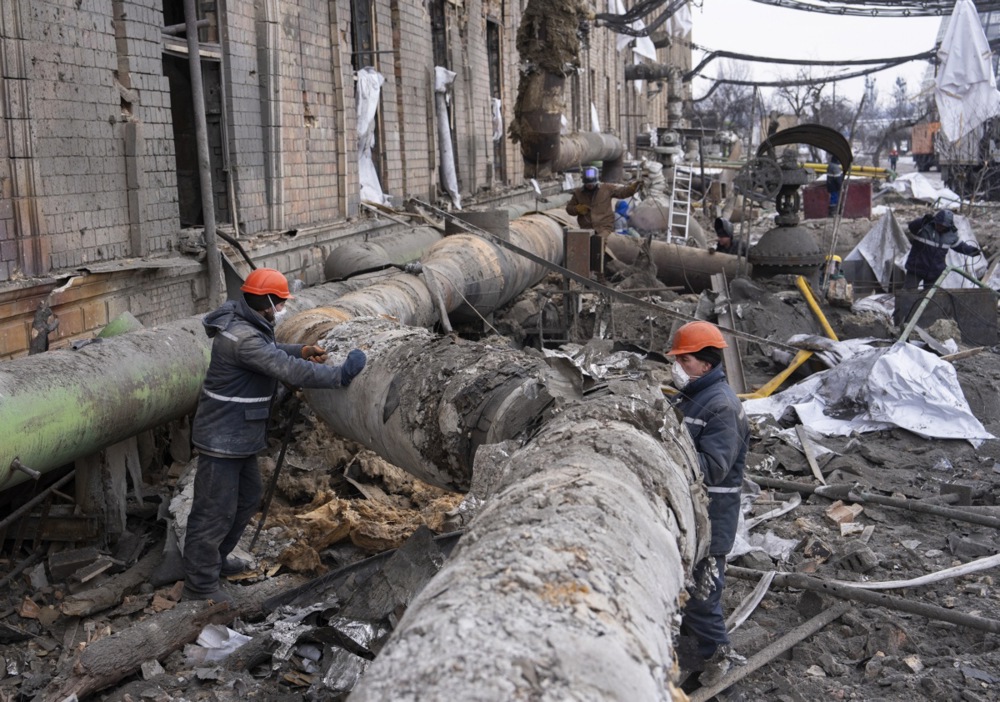 epa12704665 Ukrainian workers repair pipes at a compound of Darnytsia Thermal Power Plant which was damaged by recent Russian missile and drone strikes in Kyiv, Ukraine, 04 February 2026, amid the ongoing Russian invasion. EPA/STRINGER