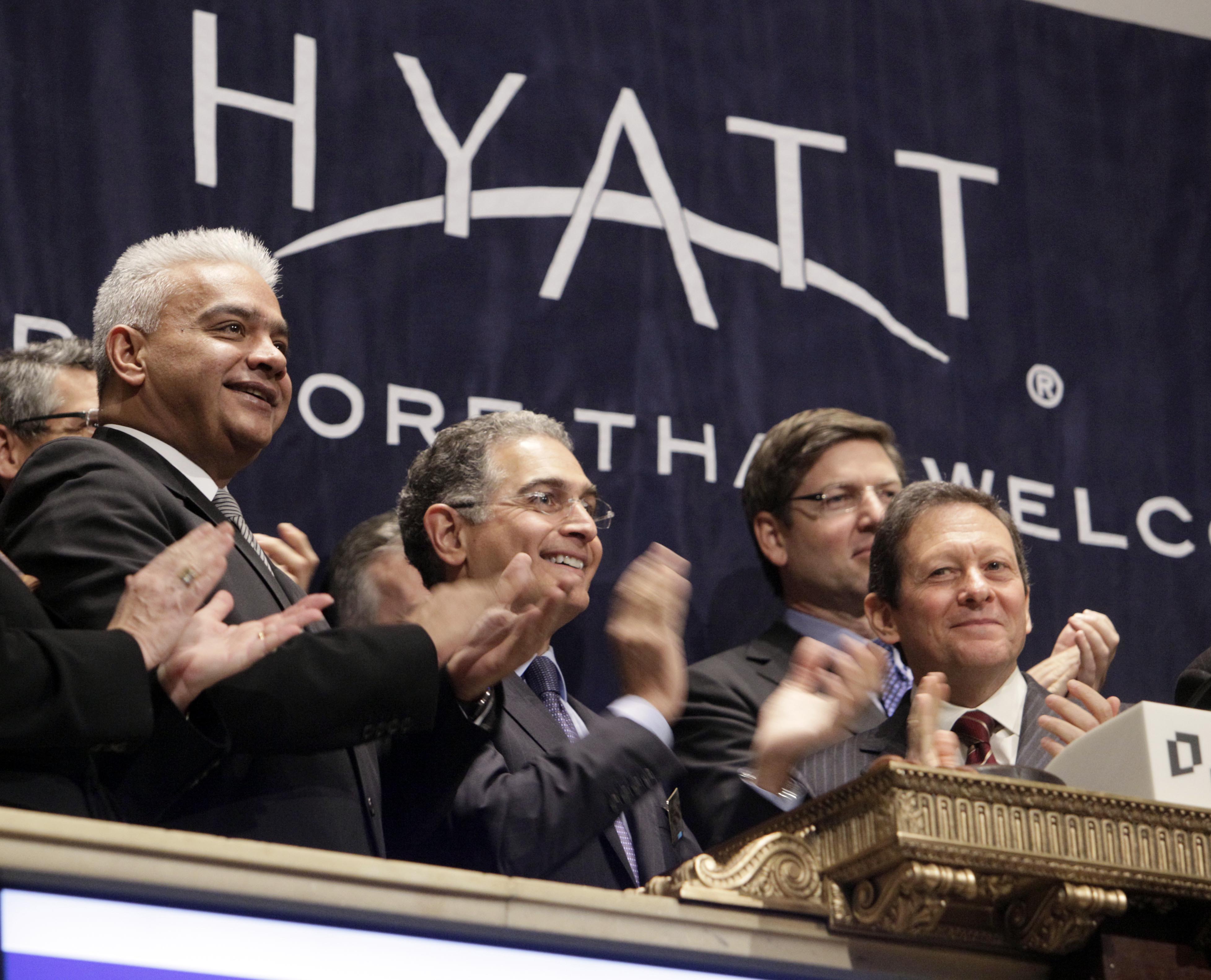 Hyatt Board Chairman Thomas Pritzker, right, Mark Hoplamazian, president and CEO, center, and Rakesh Sarna, left, COO, International Operations, ring the opening bell of the New York Stock Exchange Monday, Jan. 11, 2010. (AP Photo/Richard Drew)