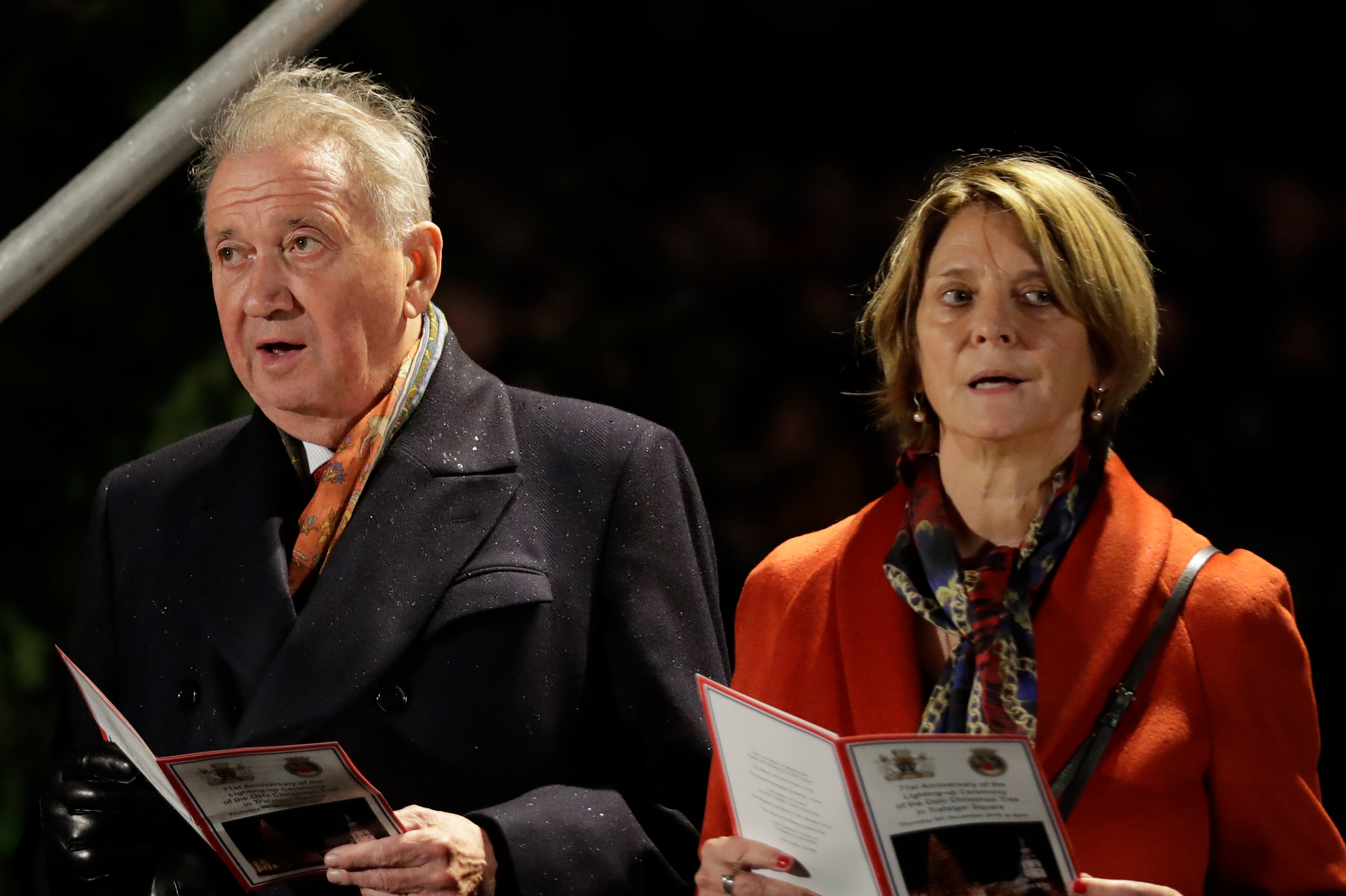The Norwegian Ambassador to Britain Mona Juul, right, and her husband Terje Rod-Larsen, a diplomat who was one of the main architects of the Oslo Accords signed 25 years ago, sing a carol during the annual Norwegian Christmas tree lighting ceremony in Trafalgar Square, London, Thursday, Dec. 6, 2018. The Christmas tree is an annual gift from the city of Oslo to the people of Britain as a token of thanks for British support during their years of occupation in World War II. (AP Photo/Matt Dunham)
