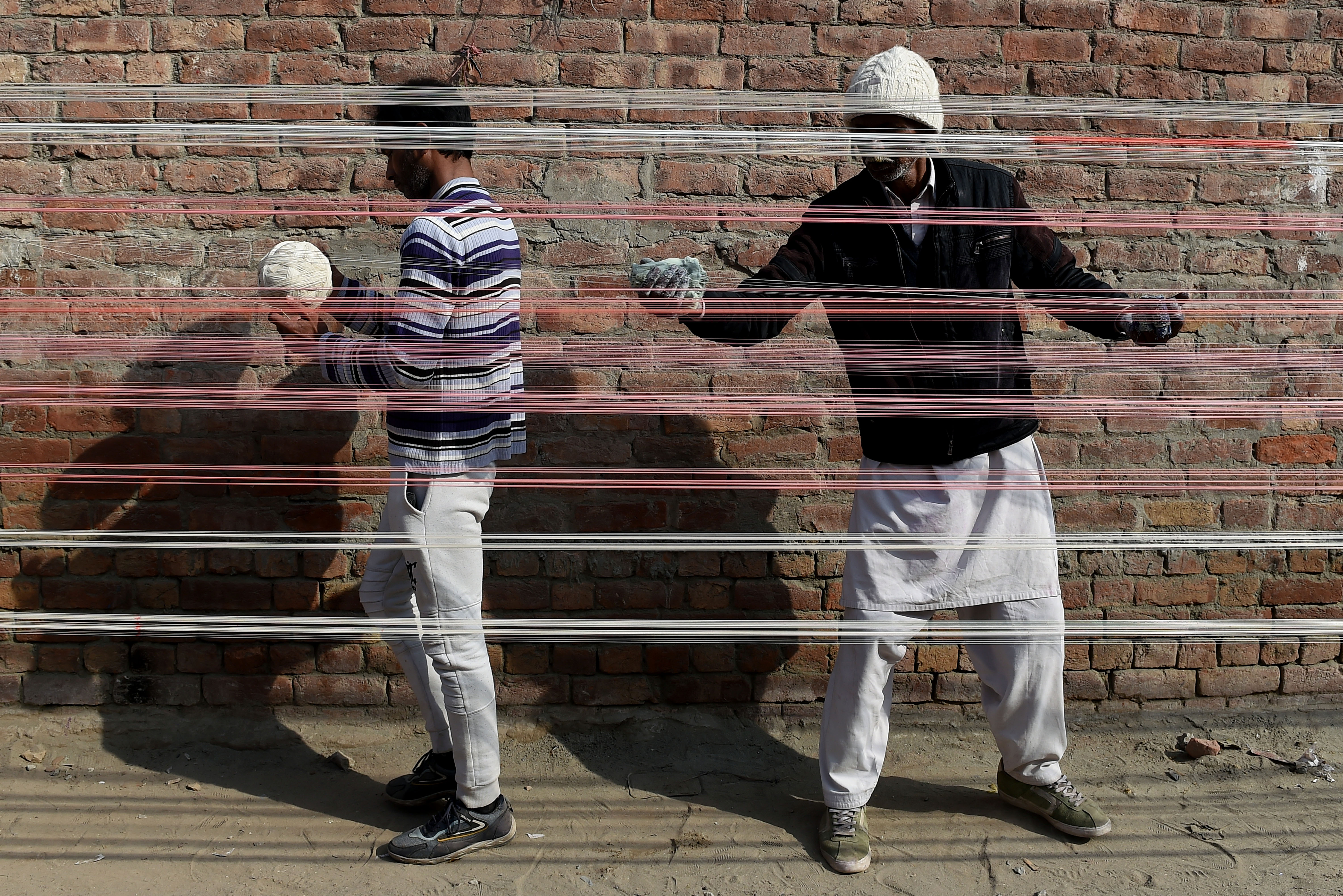 Workers prepare and arrange kite strings during preparations for the upcoming Basant Festival in Lahore, Pakistan, on January 17, 2026. (Photo by Murtaza Ali/NurPhoto via Getty Images)