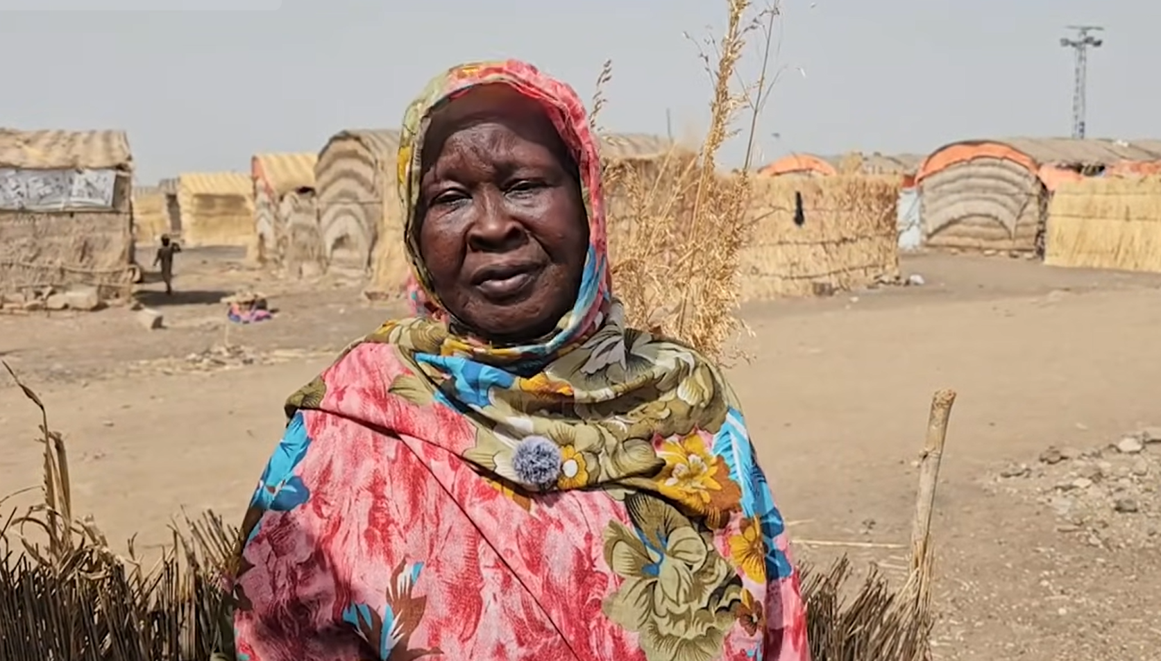 Mawaheb Ibrahim, a diabetic survivor who lost her mother and sister to shelling in El Fasher, struggles to care for orphaned children without food or medication at the Al-Sarraf camp in Al-Gedaref. [Al-Jazeera/screengrab]