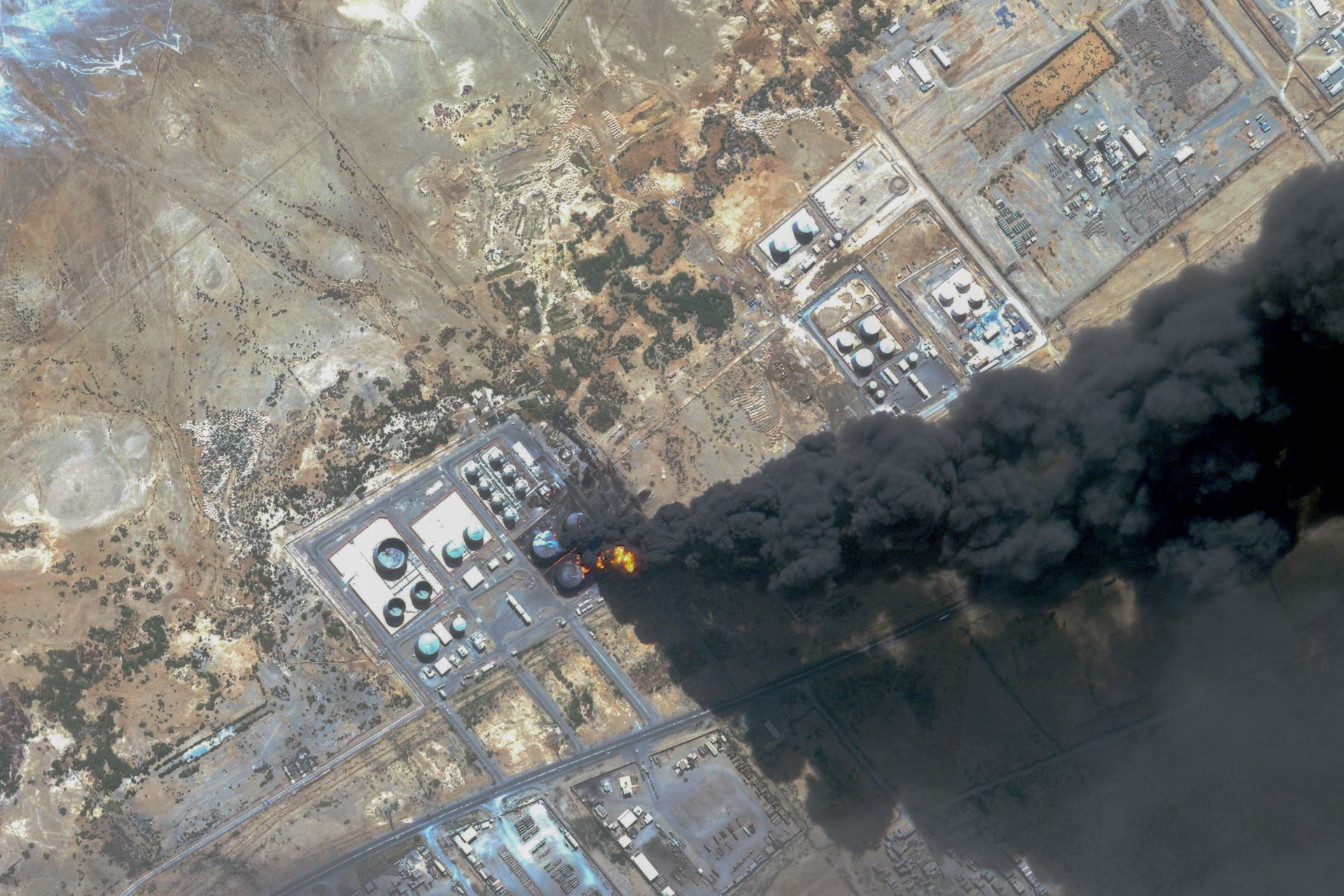 satellite photo from Planet Labs PBC shows smoke billowing from a fuel storage depot after a strike on Port Sudan