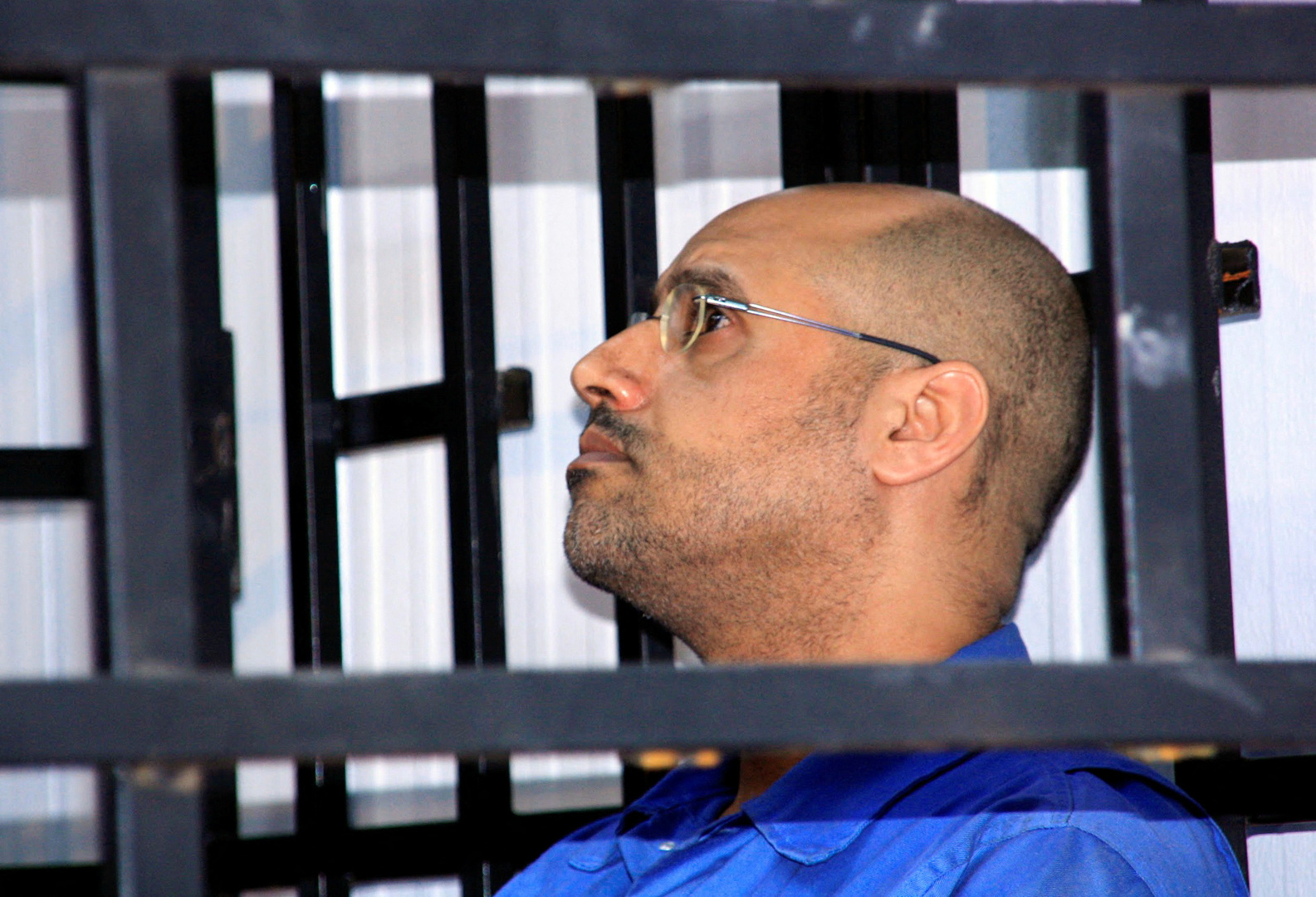 Saif al-Islam Gaddafi, son of late Libyan leader Muammar Gaddafi, attends a hearing behind bars in a courtroom in Zintan, Libya on May 25, 2014. [File: Reuters]