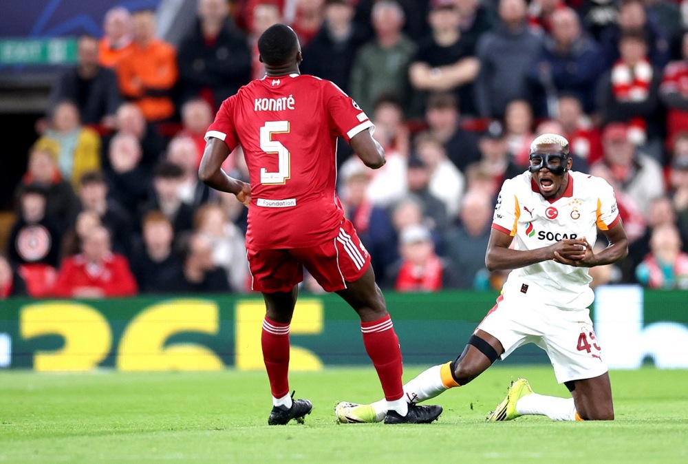 Victor Osimhen (R) of Galatasaray goes down with an injury during a match.