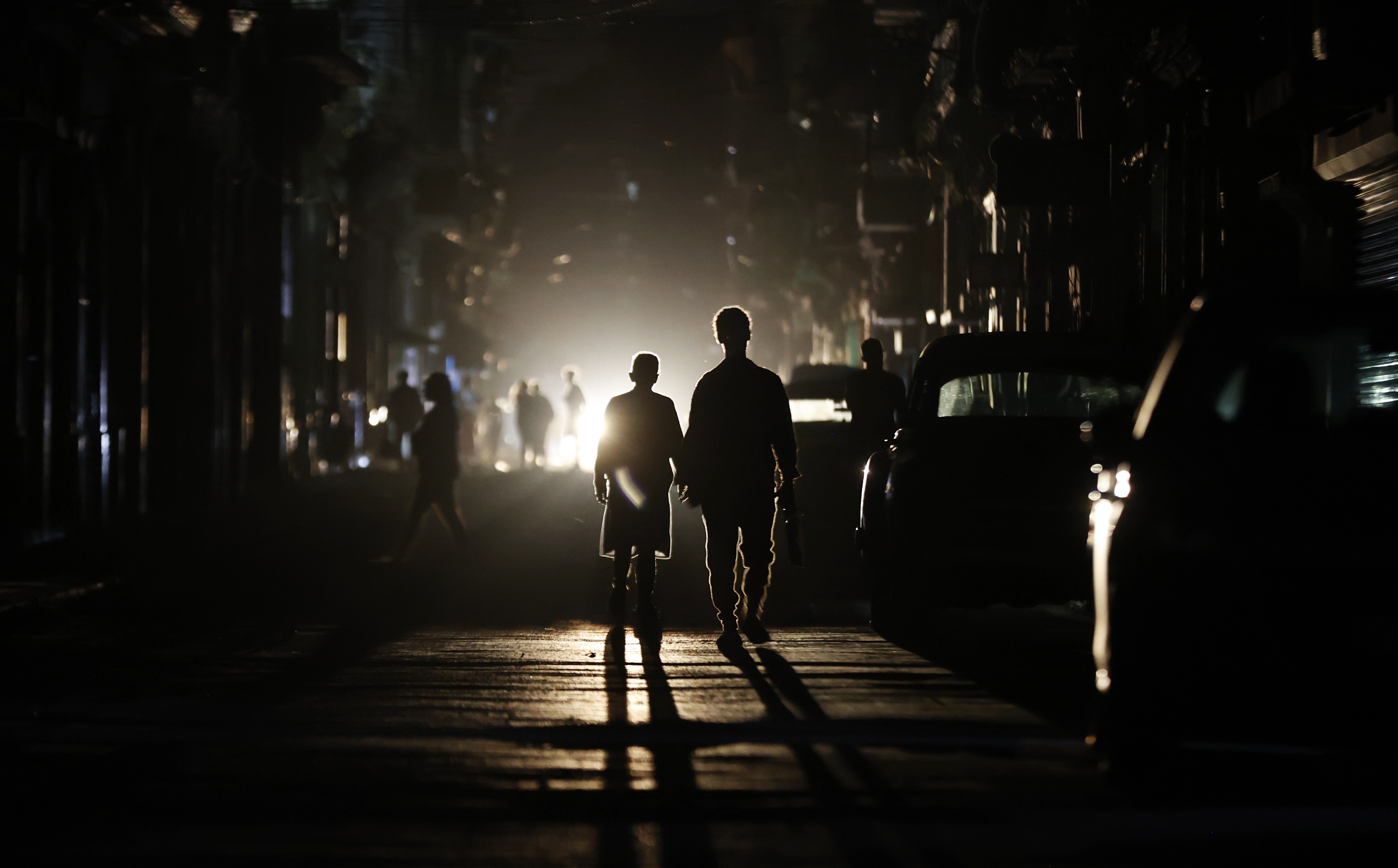 eople walk down a street during a national power outage, in Havana, Cuba