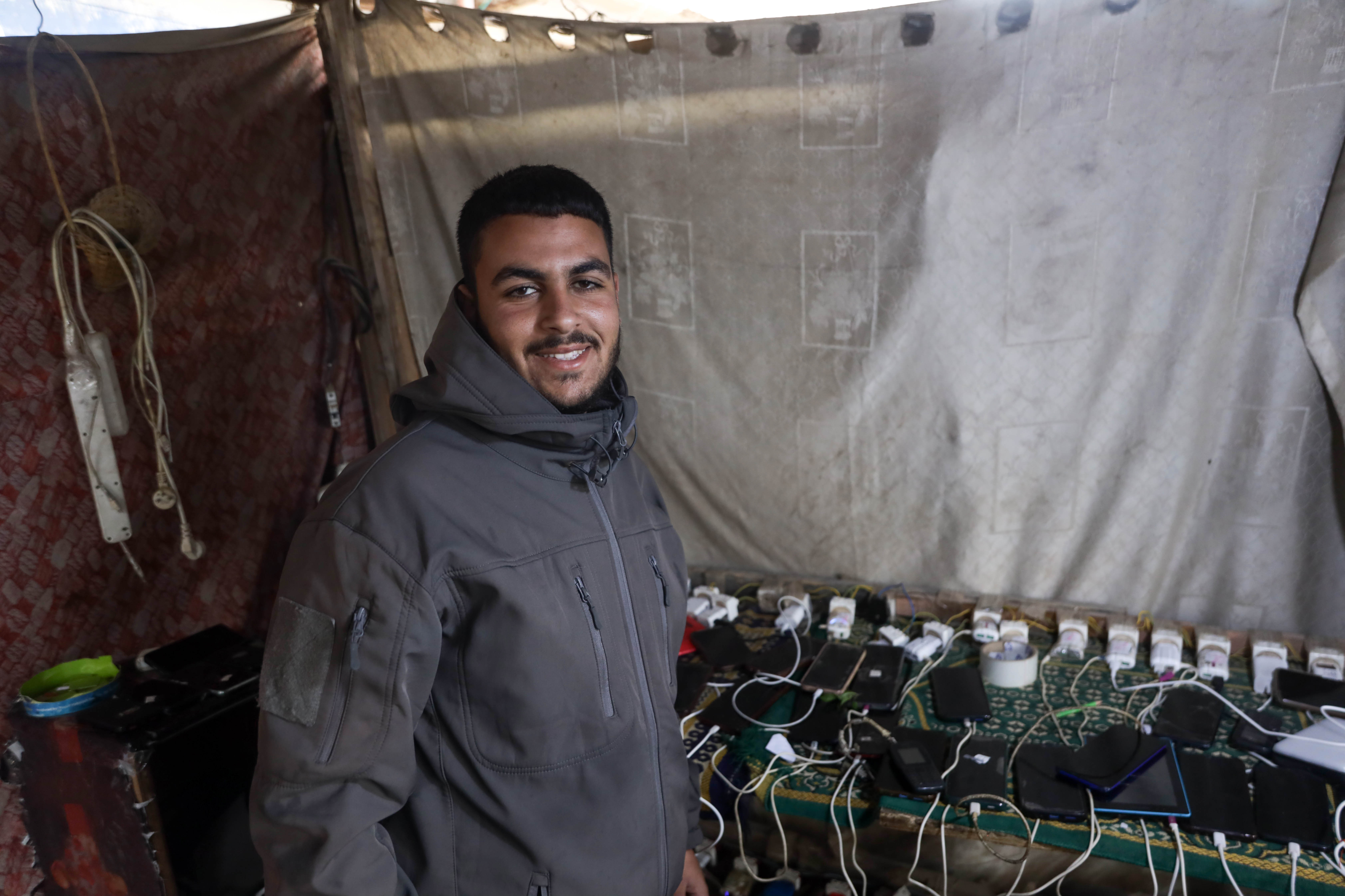 Man stands in front of a charging station