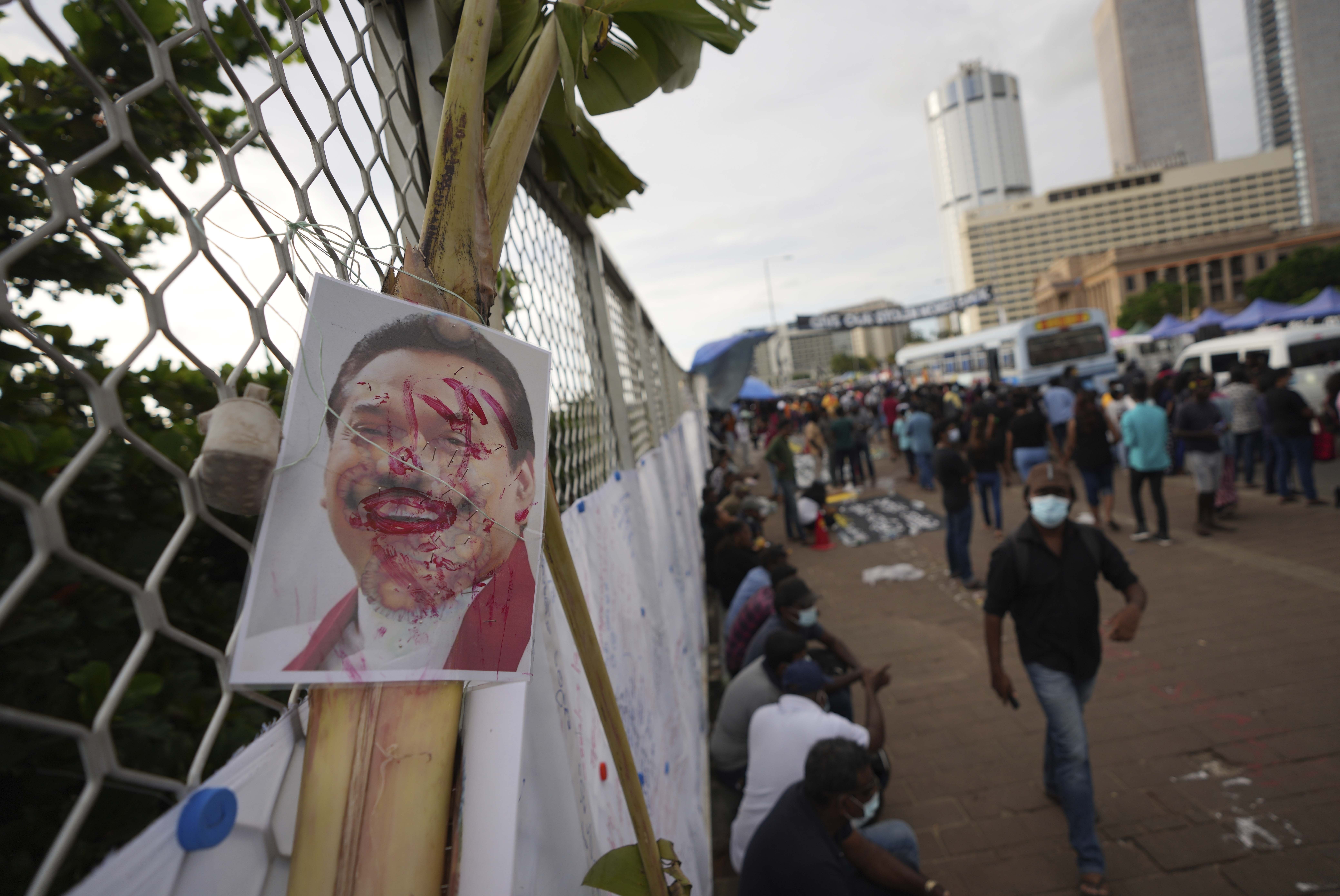 A vandalised portrait of Prime Minister Mahinda Rajapaksa is seen at a protest site.