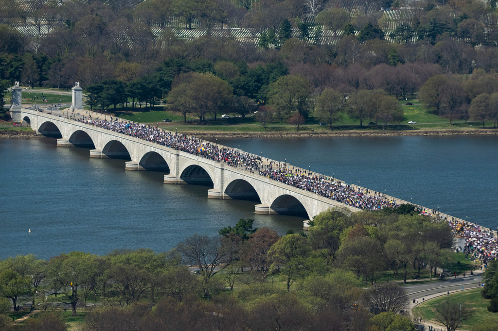 marchers cross a bridge in Washington DC